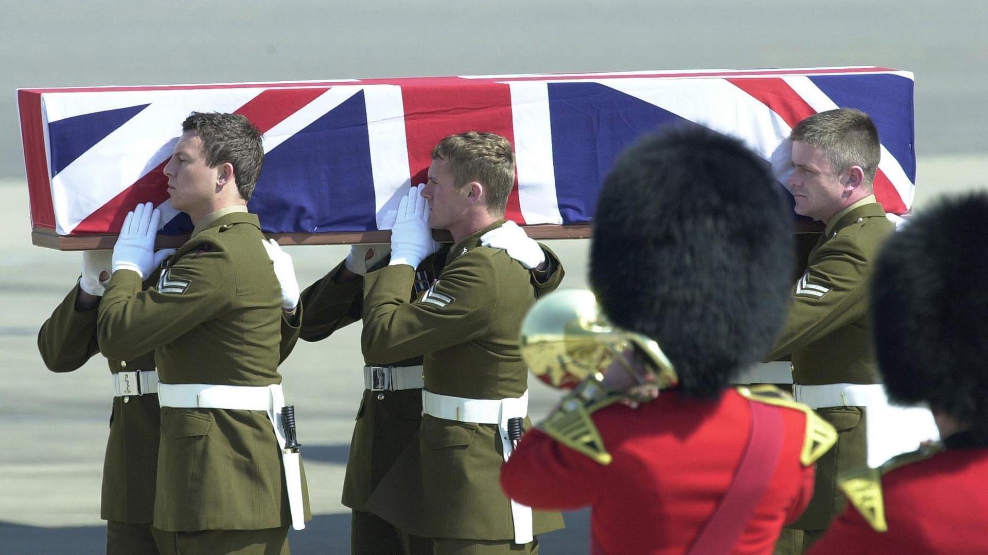 The coffin of Lance Corporal Shaun Brierley, of Britain's 212 Signal Squadron, who was killed on duty in the Gulf on March 30, is carried from a Boeing C-17 aircraft at RAF Brize Norton in Oxforshire, Britain, April 8, 2003.