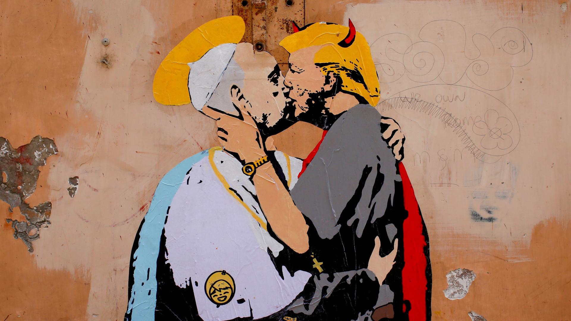 A mural signed by "TV Boy" and depicting Pope Francis and U.S. President Donald Trump kissing, is seen on a wall in downtown Rome, Italy May 11, 2017.