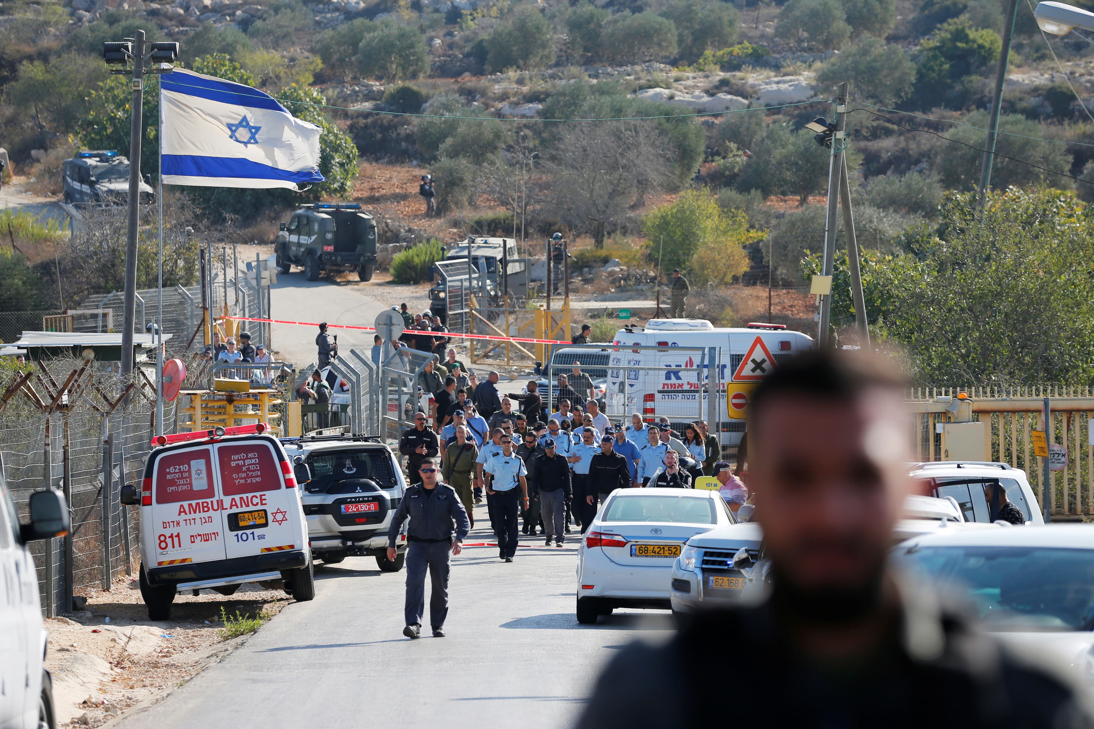 Israeli security personnel investigating a street where a police spokeswoman said a Palestinian gunman killed three Israelis guards.