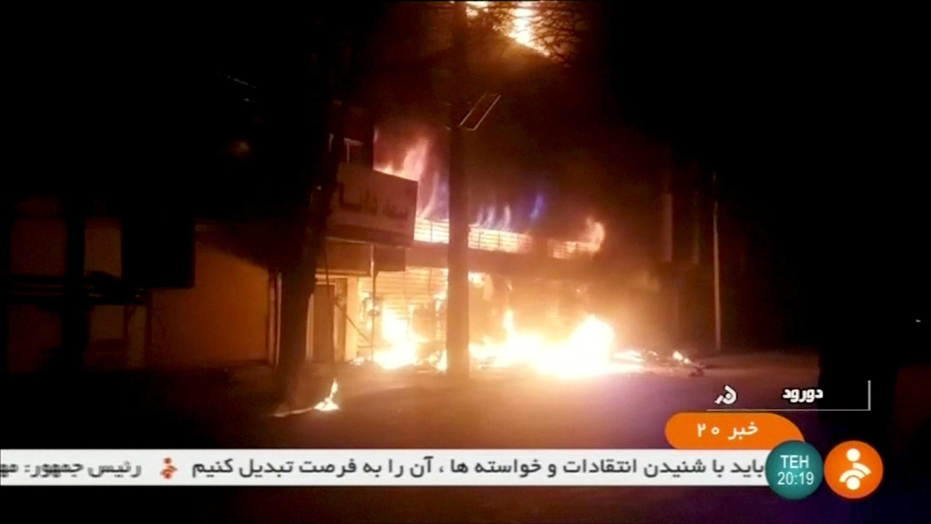 A building burns during street protests in Dorud, Iran.