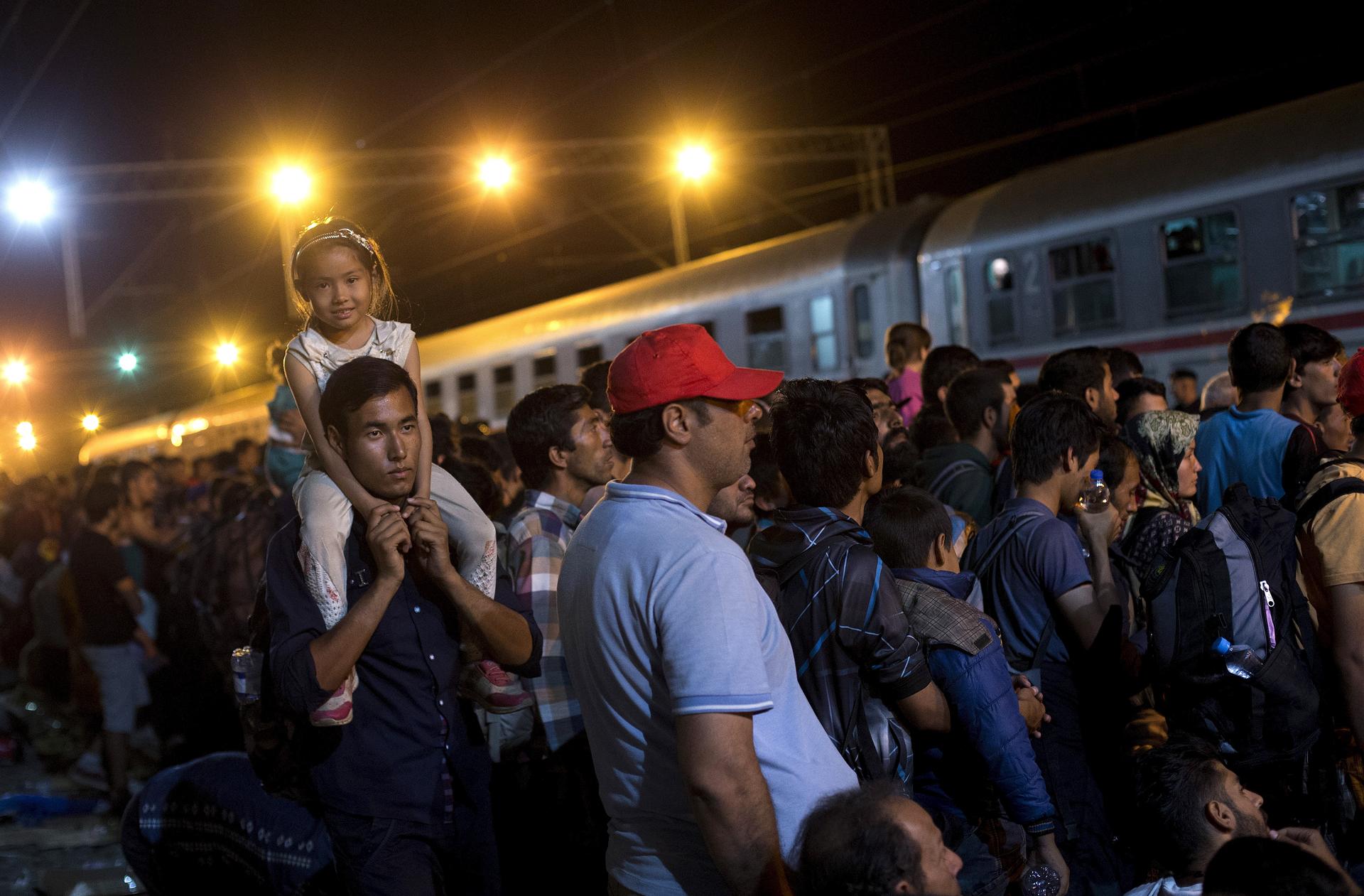 Migrants wait to board a train at the train station in Tovarnik, Croatia.