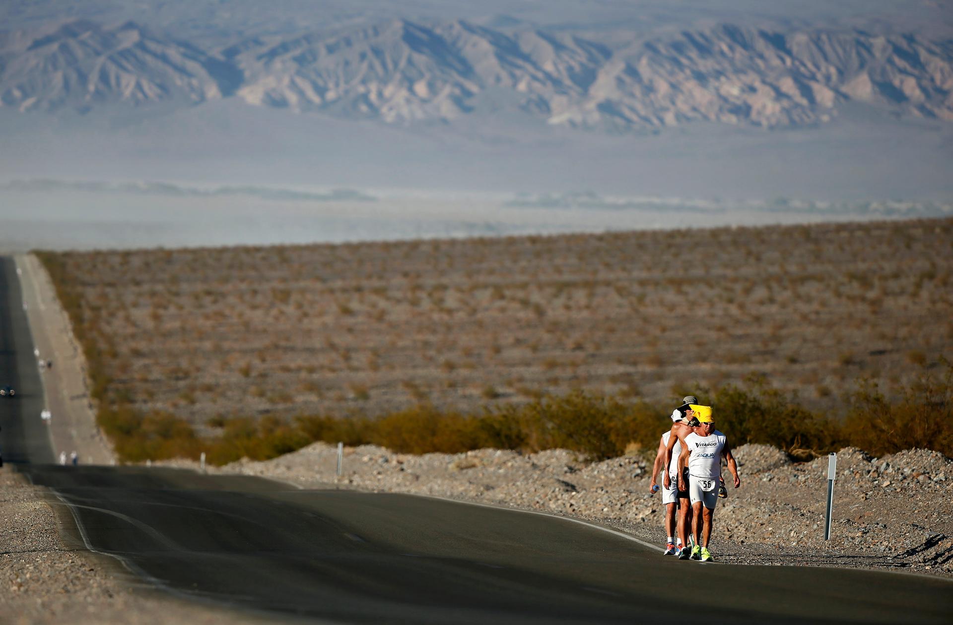 Competitors run in the 2013 Badwater Ultramarathon in Death Valley National Park, California. The 135-mile (217 km) race, which bills itself as the world's toughest foot race, goes from Death Valley to Mt. Whitney, California. Temperatures can reach 130 d