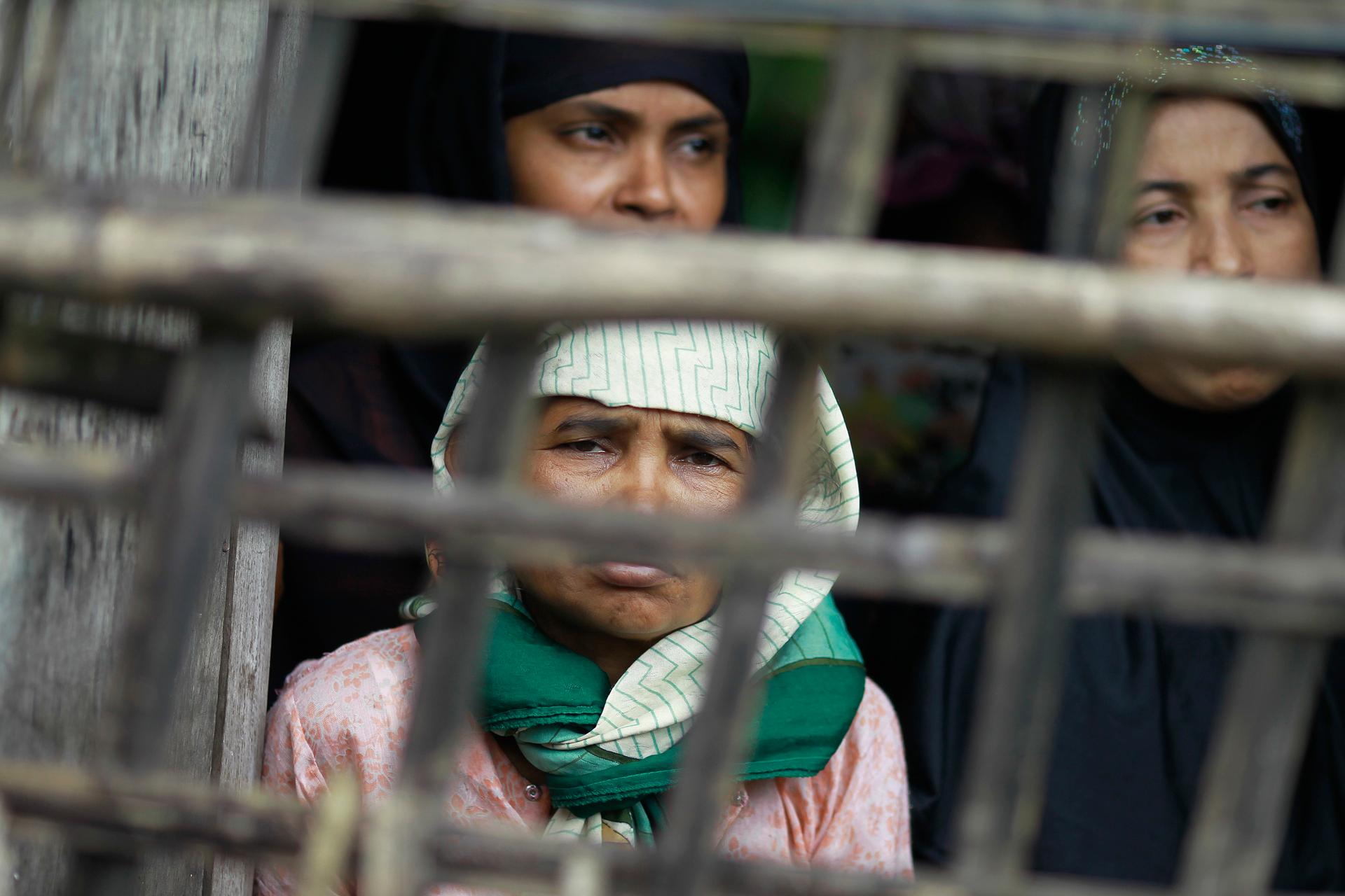 Rohingya Muslim women look out from their home at Aung Mingalar quarter in Sittwe, Myanmar