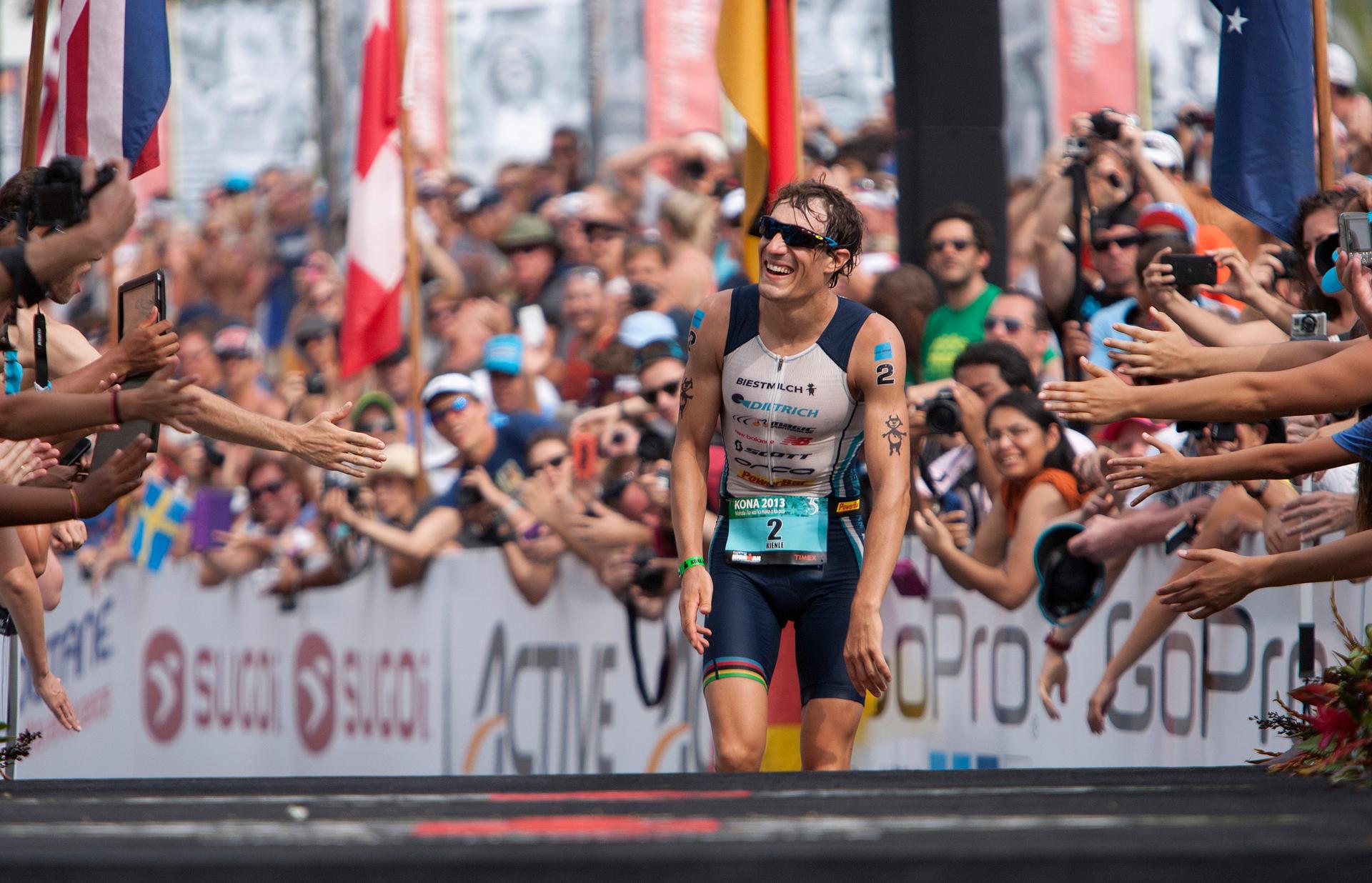 Triathlete Sebastian Kienle of Germany reacts to the crowd after coming in third place at the Ironman World Championship in Kailua-Kona, Hawaii, October 12, 2013
