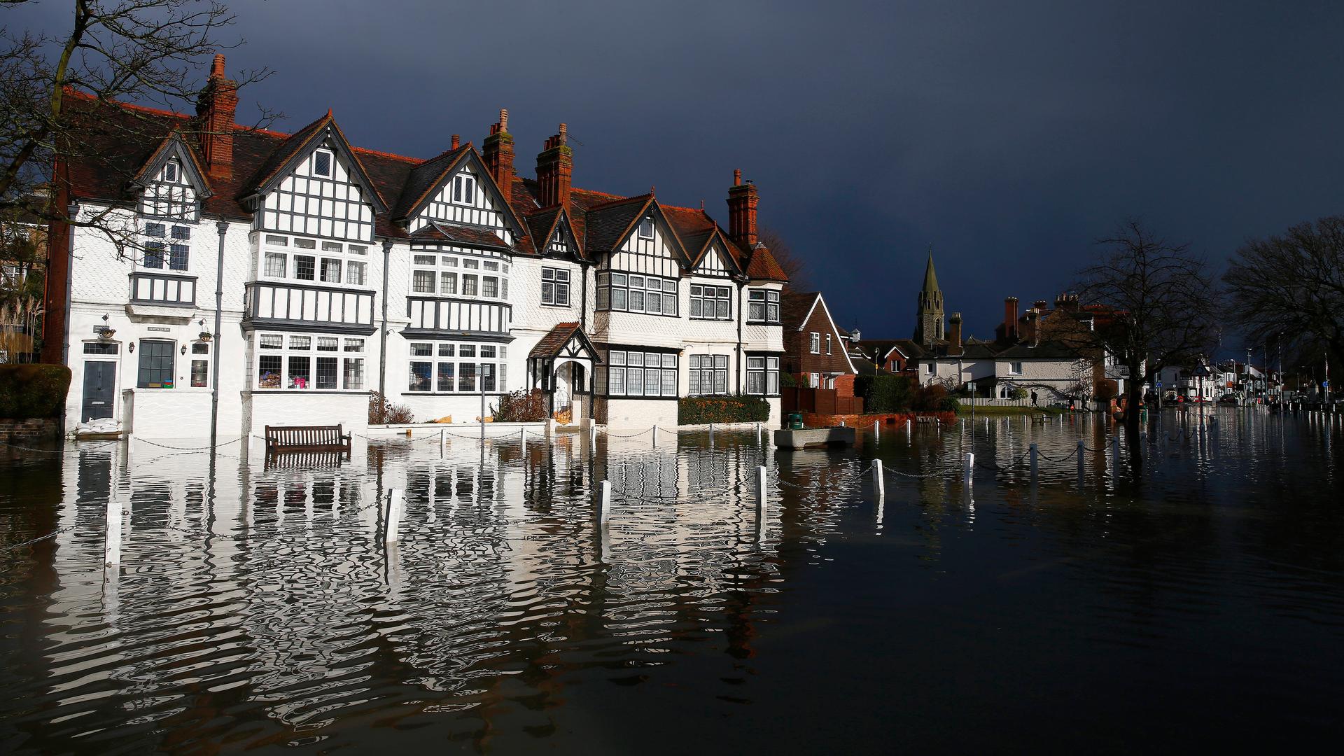 The river Thames floods the village of Datchet, southern England February 10, 2014. The British Government's top climate science agency says this winter's unrelenting rain is likely due at least in part to climate change.