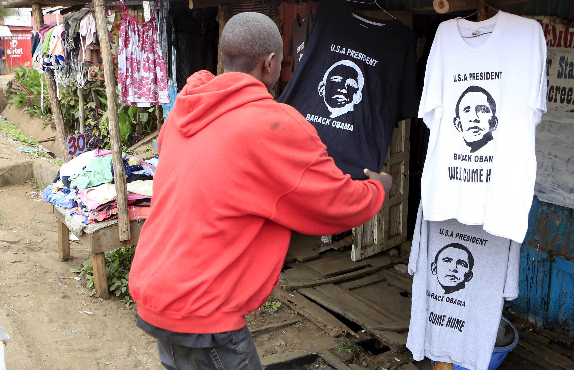 A customer looks at a t-shirt displaying the image of U.S. President Barack Obama at a stall in the Kibera slums, ahead of his scheduled state visit, in Kenya's capital Nairobi July 23, 2015.