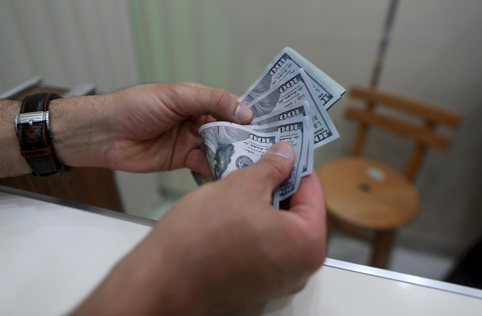 A man buys U.S. dollars in a currency exchange in Benghazi, Libya.