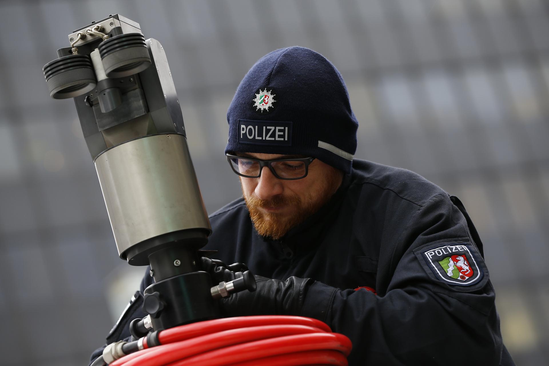 A police officer sets-up a mobile surveillance camera.