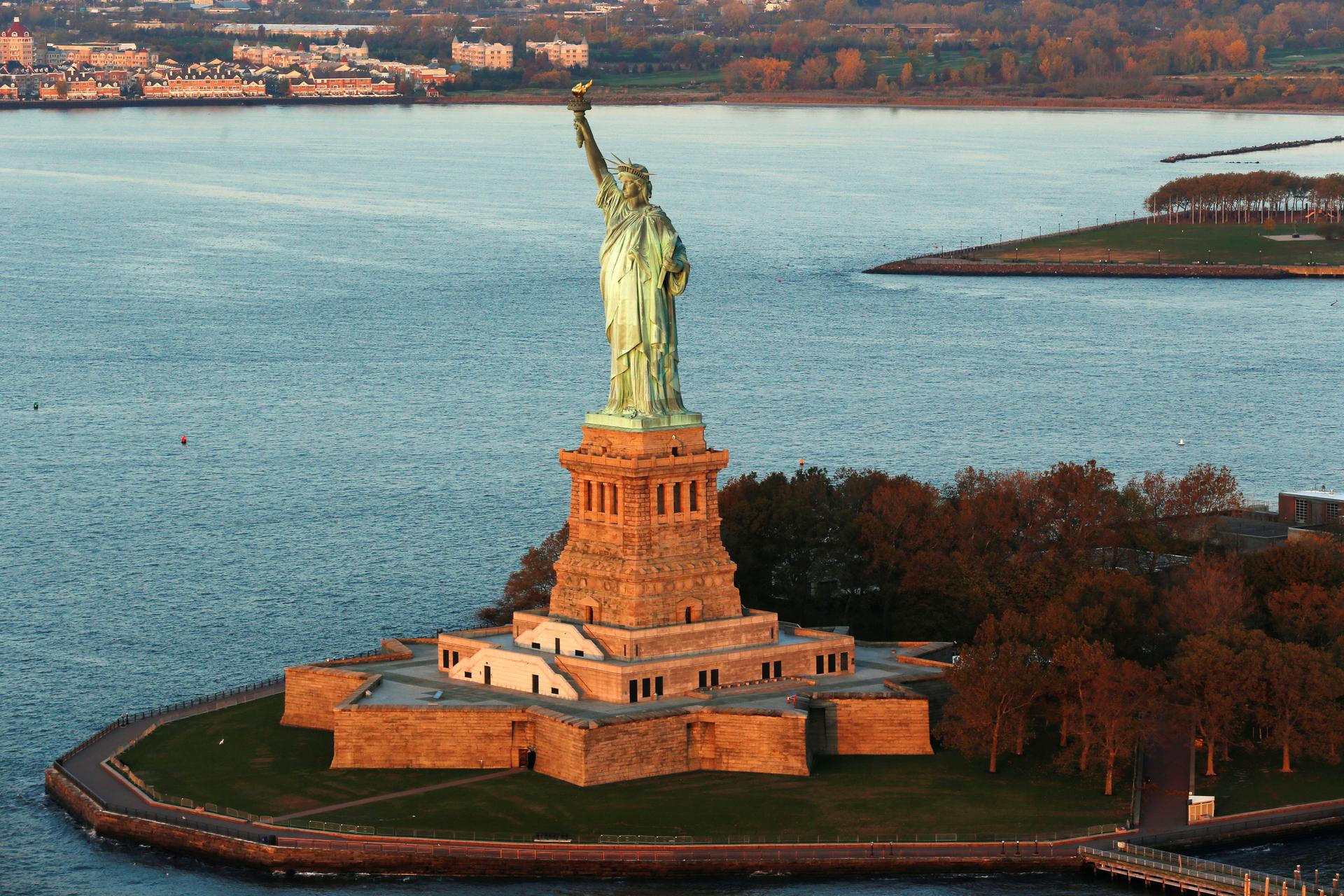 The sun lights the Statue of Liberty in New York, November 2016