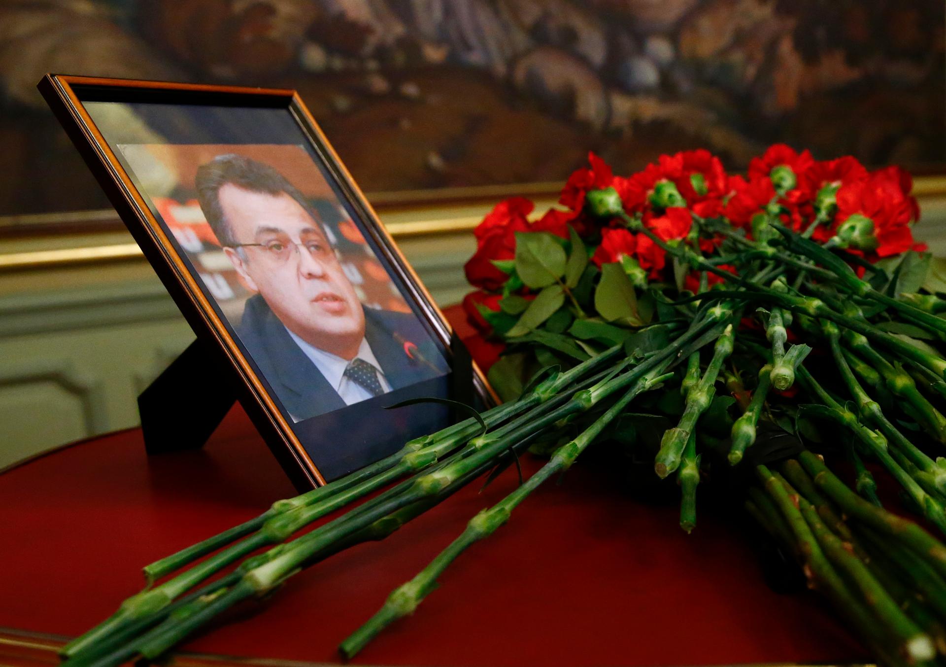 Flowers are placed near a portrait of murdered Russian ambassador to Turkey Andrei Karlov
