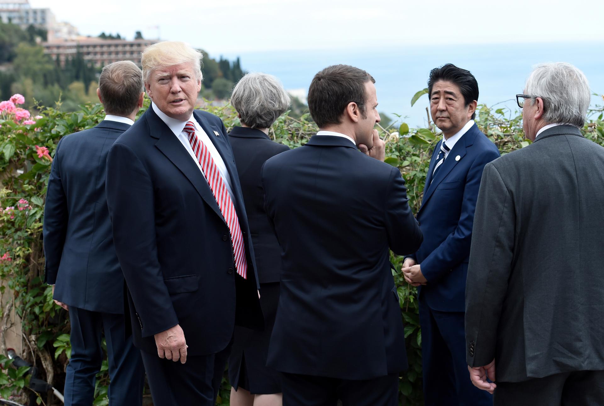 Trump turns away from President of the European Council Donald Tusk, Britain's Prime Minister Theresa May, French President Emmanuel Macron, Japanese Prime Minister Shinzo Abe and President of the European Commission Jean-Claude Juncker.