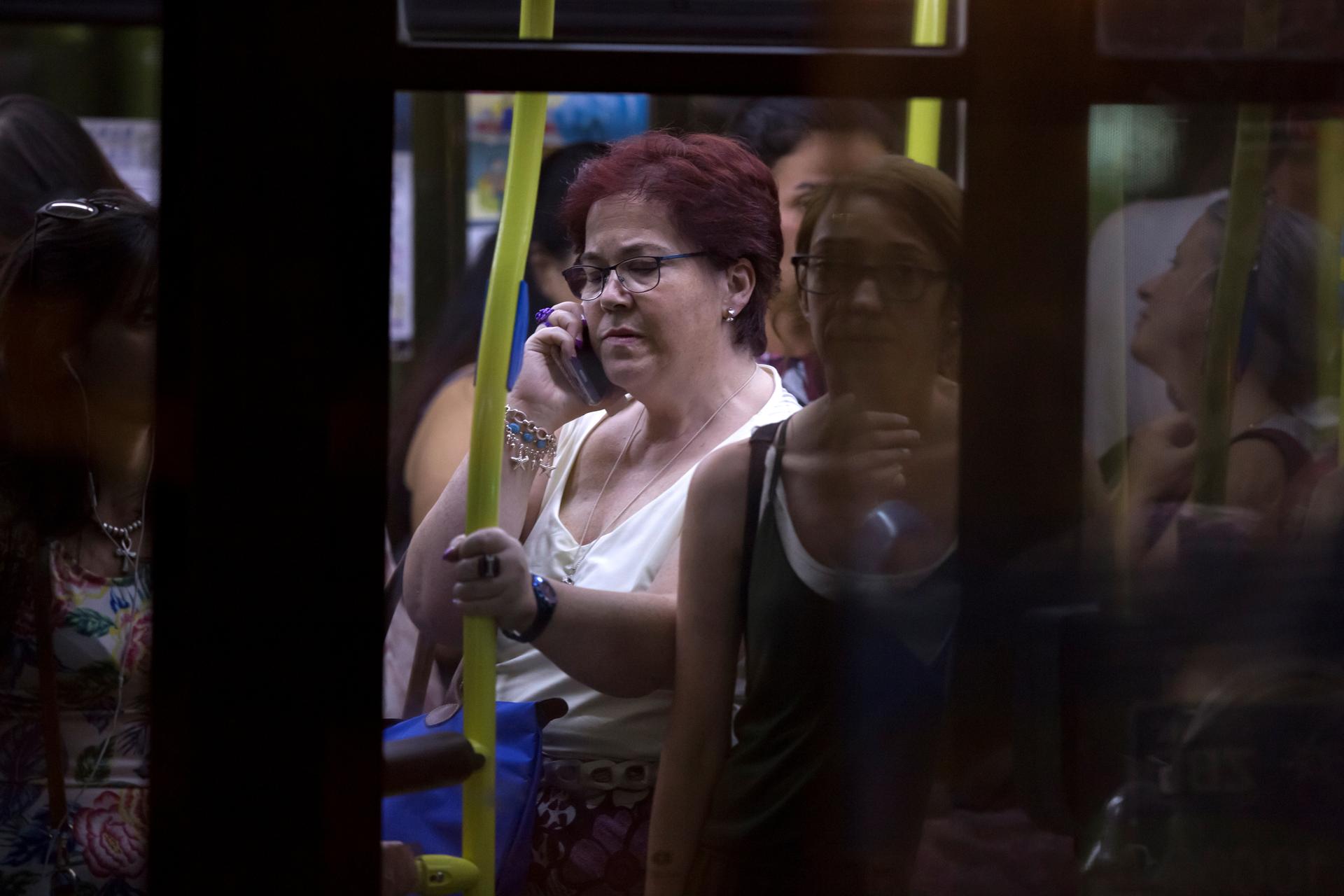 A woman talks on her cellphone on a bus in Madrid.