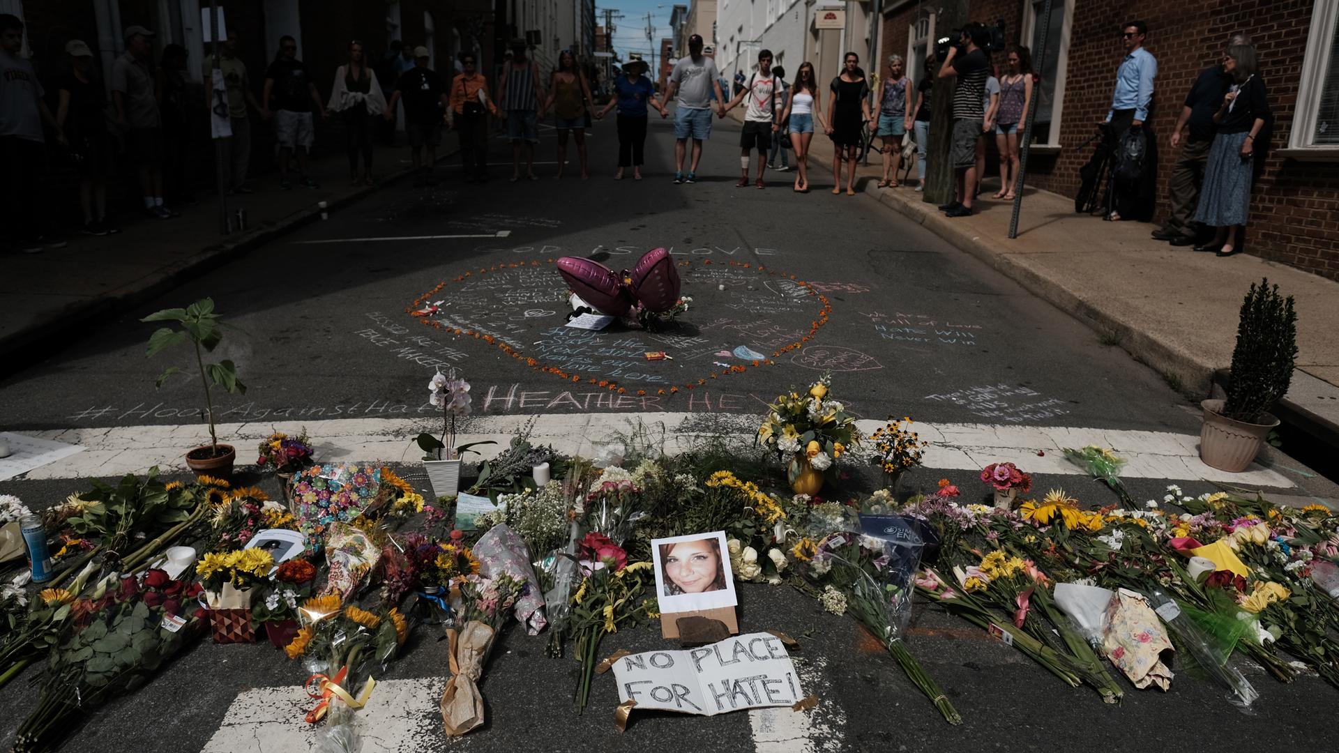 Flowers and a photo of car-ramming victim Heather Heyer lie at a makeshift memorial in Charlottesville, Virginia.