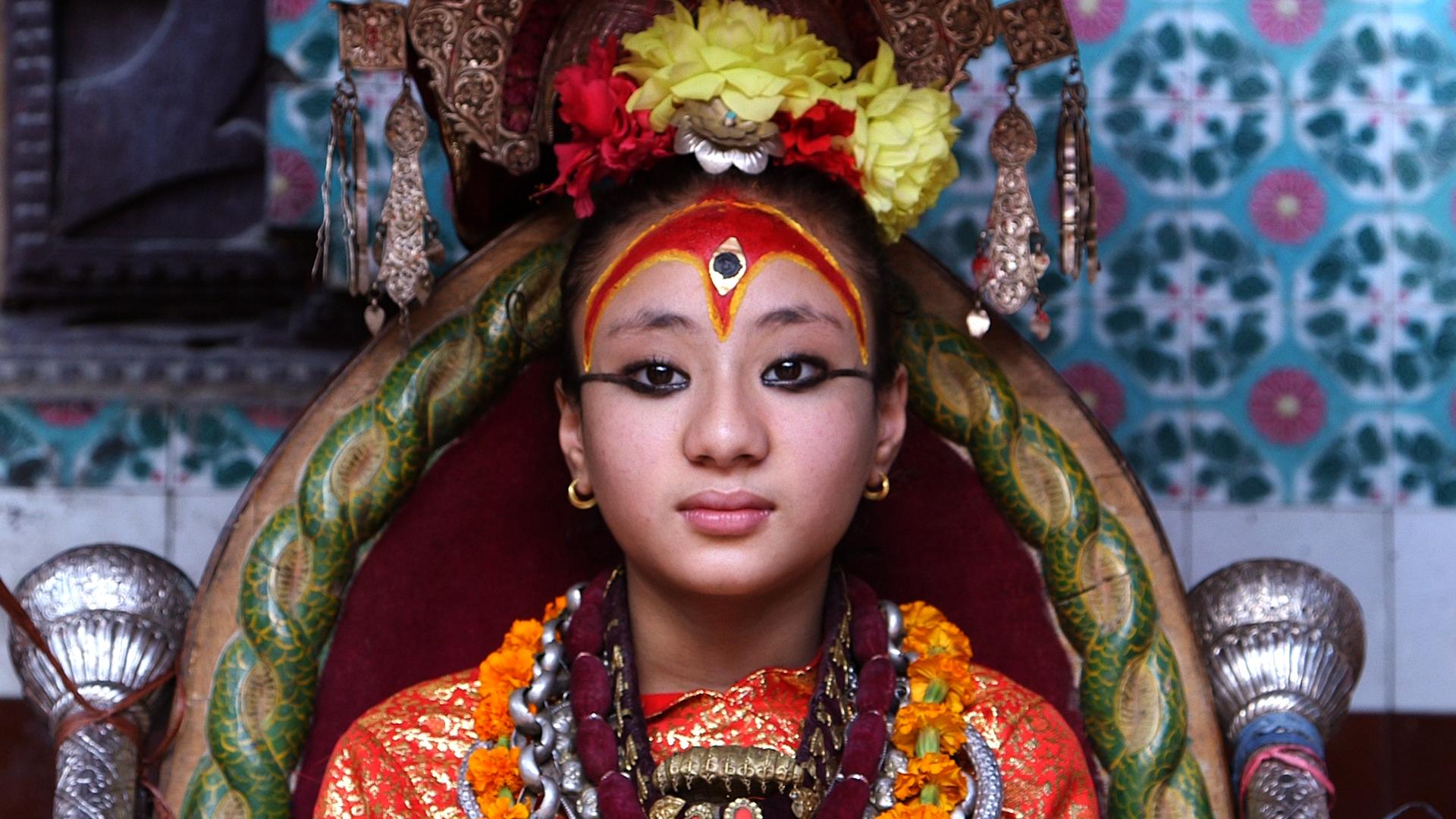 The Living Goddess, known as a Kumari Devi, is worshipped in Nepal by Hindus and Buddhists alike. Each Kumari Devi is chosen at a very young age. Samita, the girl in this picture, is no longer a Kumari Devi. Since the photo was taken, she started mentruat