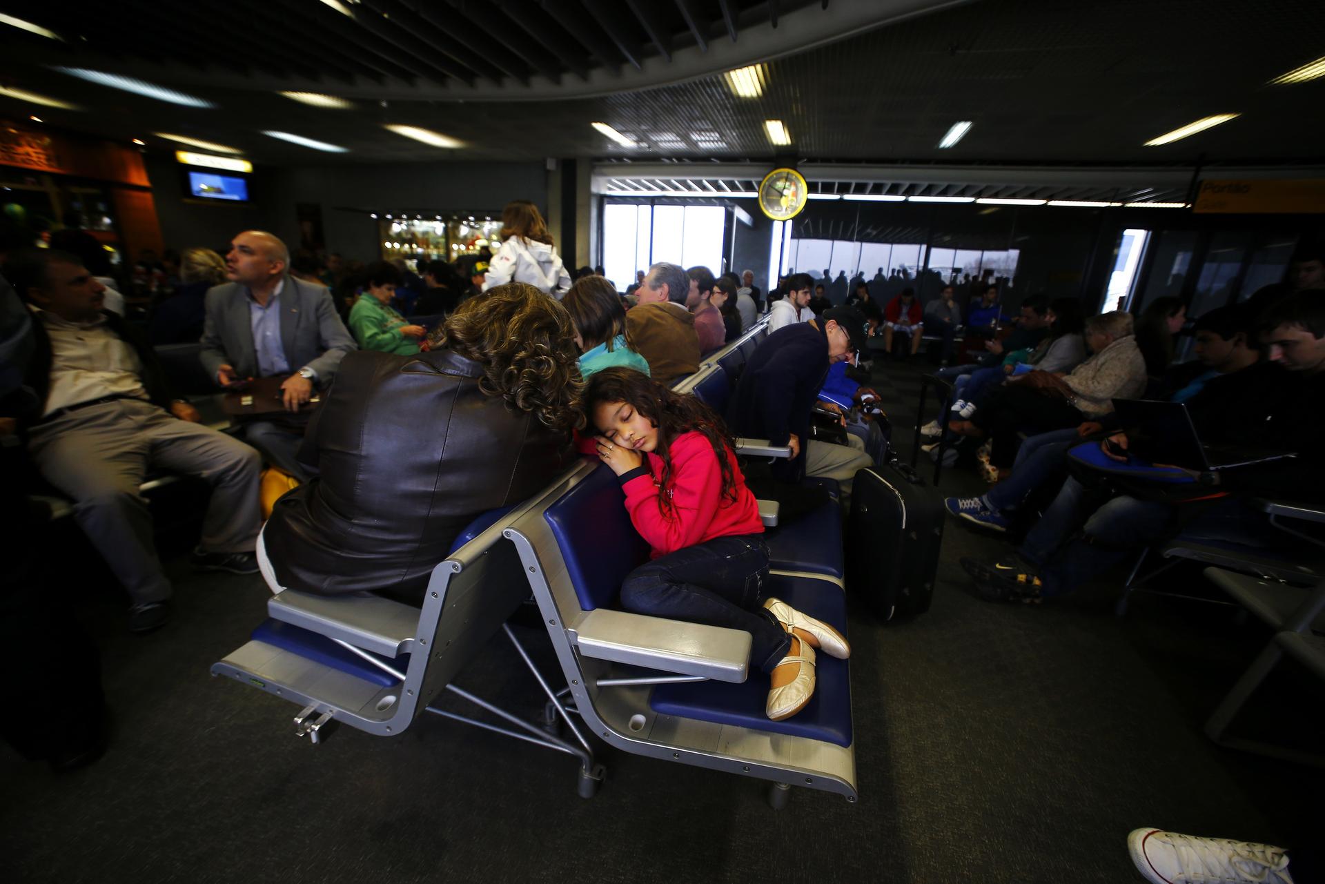 Passengers wait for their delayed flights at Alfonso Pena airport in Curitiba city.