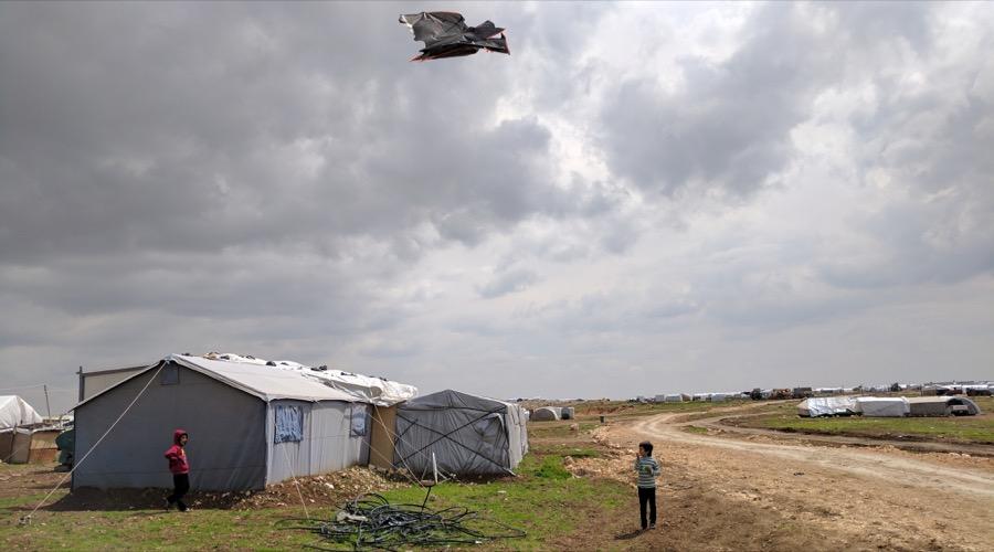Children play with a kite at a shelter for displaced Yazidis on Mount Sinjar, northern Iraq.