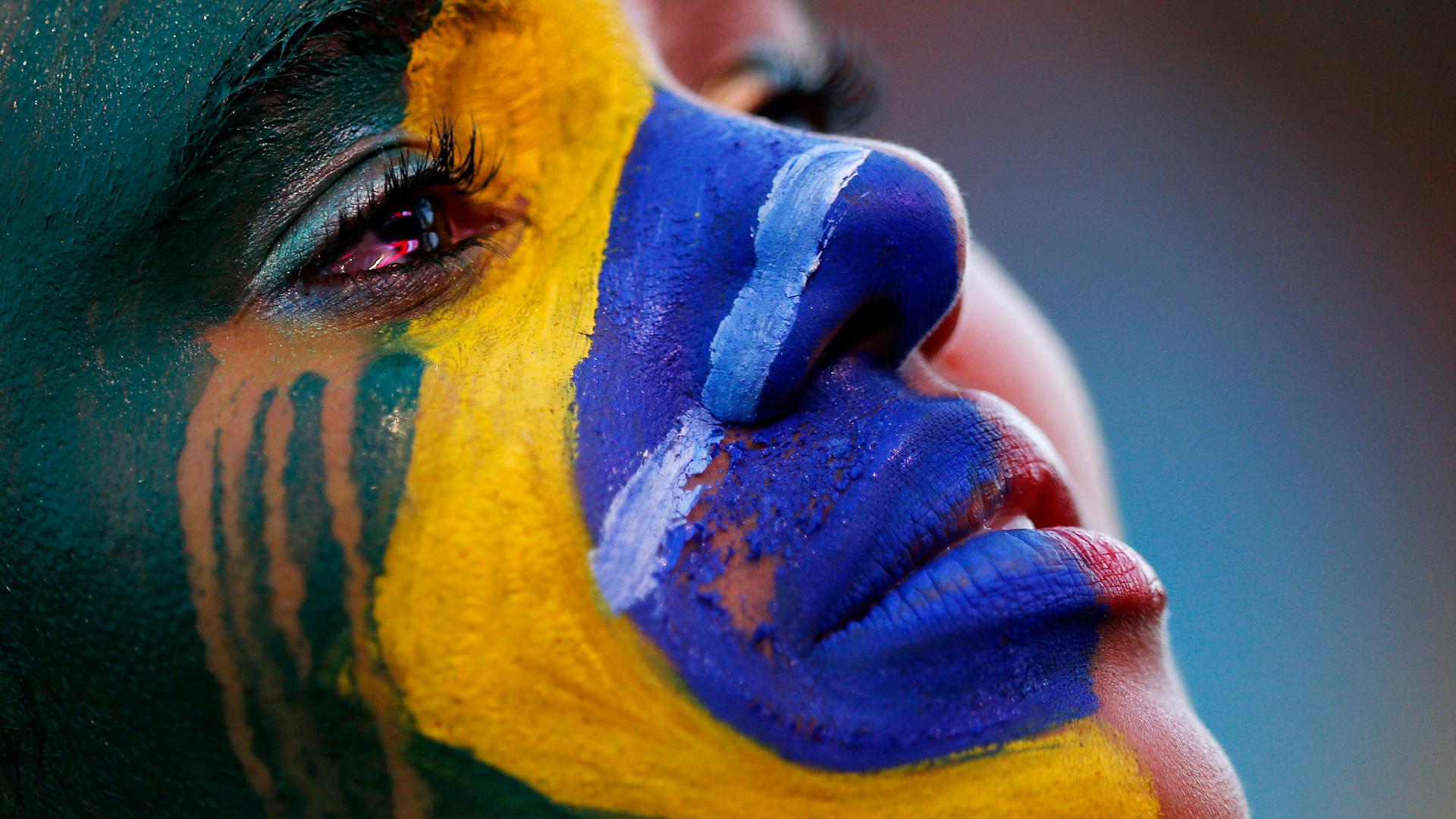A Brazil fan cries as she watches the 2014 World Cup semi-final between Brazil and Germany at a fan area in Brasilia. Germany scored five goals in 18 astonishing first-half minutes on their way to a 7-1 semi-final mauling of Brazil on Tuesday.
