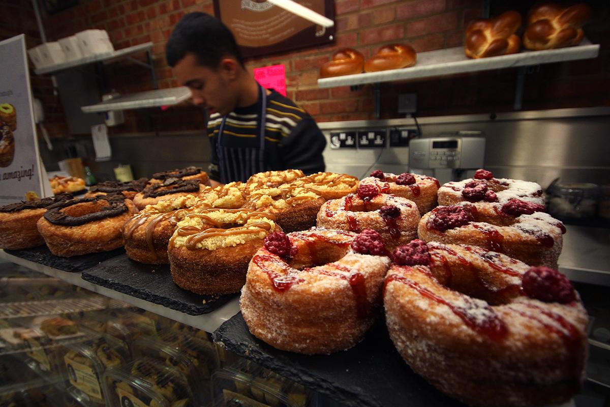A baker in London's Rinkoff Bakery shows off his cronuts.