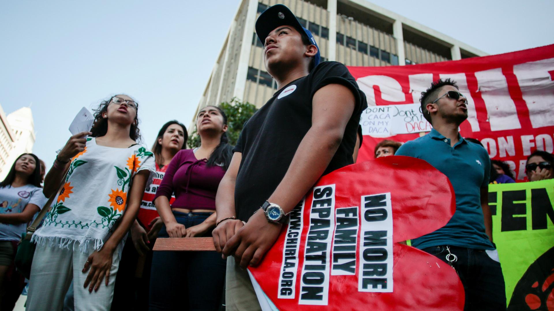 Axel, 15, the son of a Deferred Action for Childhood Arrivals (DACA) program recipient, stands with supporters during a rally outside the Federal Building in Los Angeles, California, U.S., September 1, 2017.