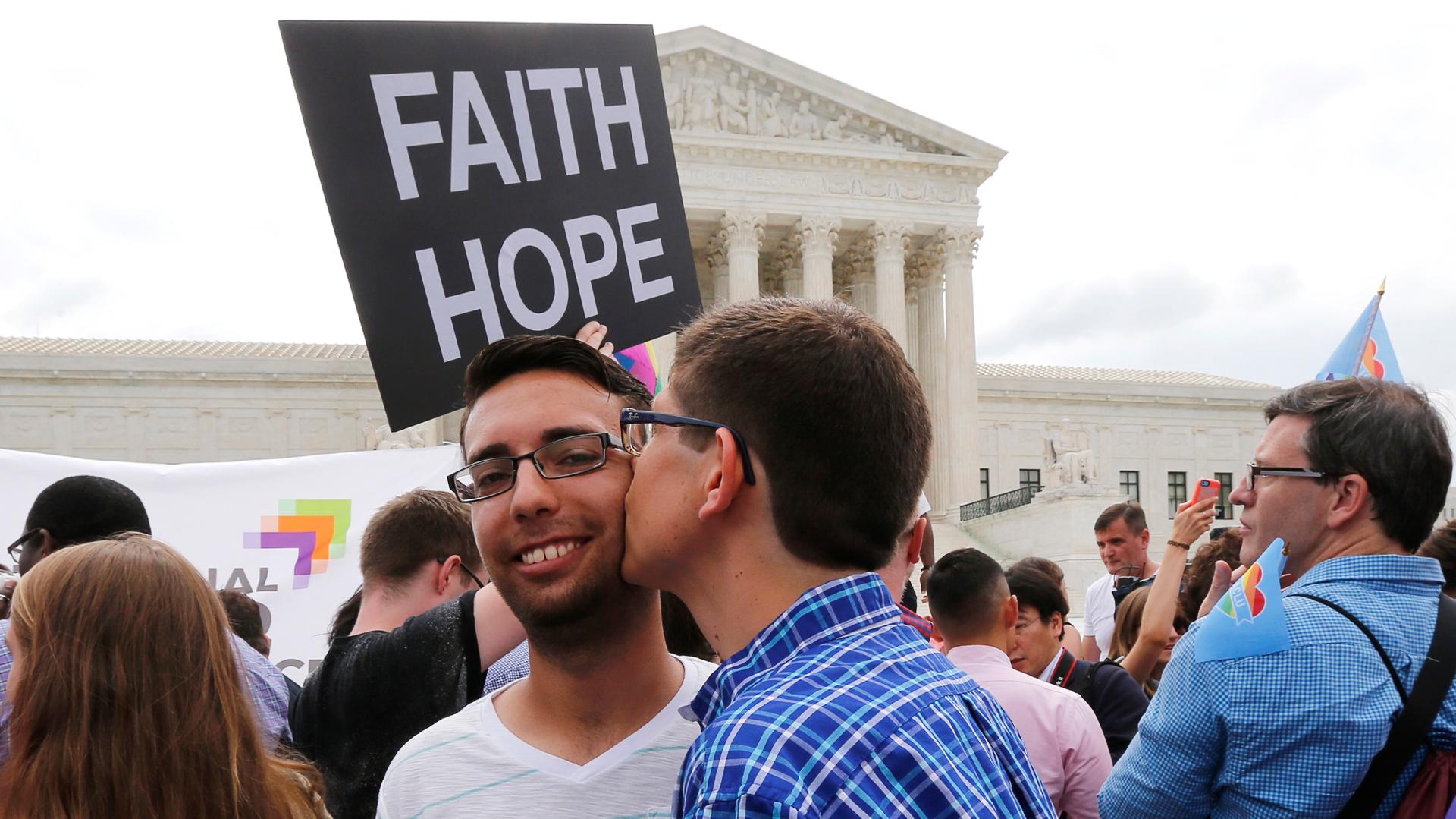 Gay rights supporters celebrate outside the Supreme Court building in Washington on June 26, 2015. The court ruled 5-4 that the Constitution's guarantees of due process and equal protection under the law mean that states cannot ban same-sex marriages.