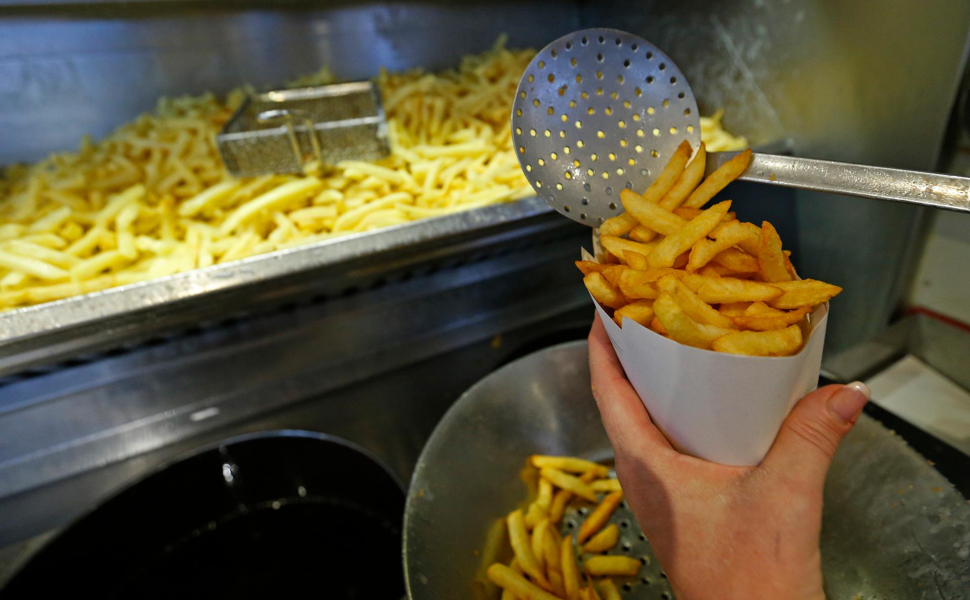 Carine Willaert prepares fries in the Maison Antoine frites stand