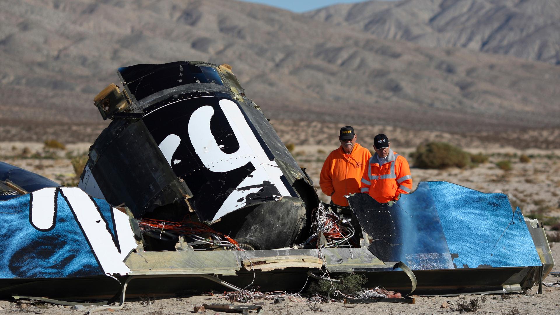 Sheriffs' deputies look at wreckage from the crash of Virgin Galactic's SpaceShipTwo near Cantil, California November 2, 2014. A suborbital passenger spaceship being developed by Richard Branson's Virgin Galactic company crashed during a test flight on Fr