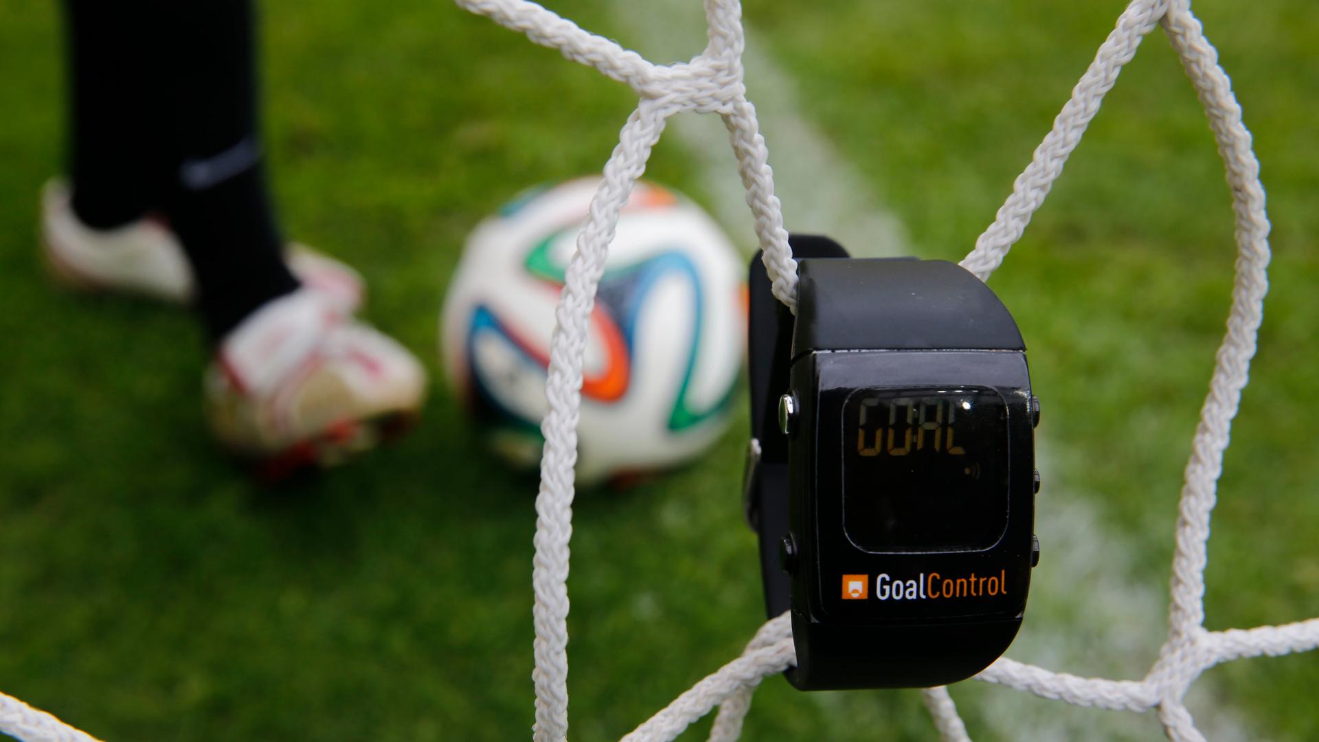 A GoalControl watch reads "goal" as a football rolls fully behind the goal line during a demonstration in the western German city of Aachen May 28, 2014. German firm GoalControl has been appointed by FIFA as the official provider for the goal-line technol