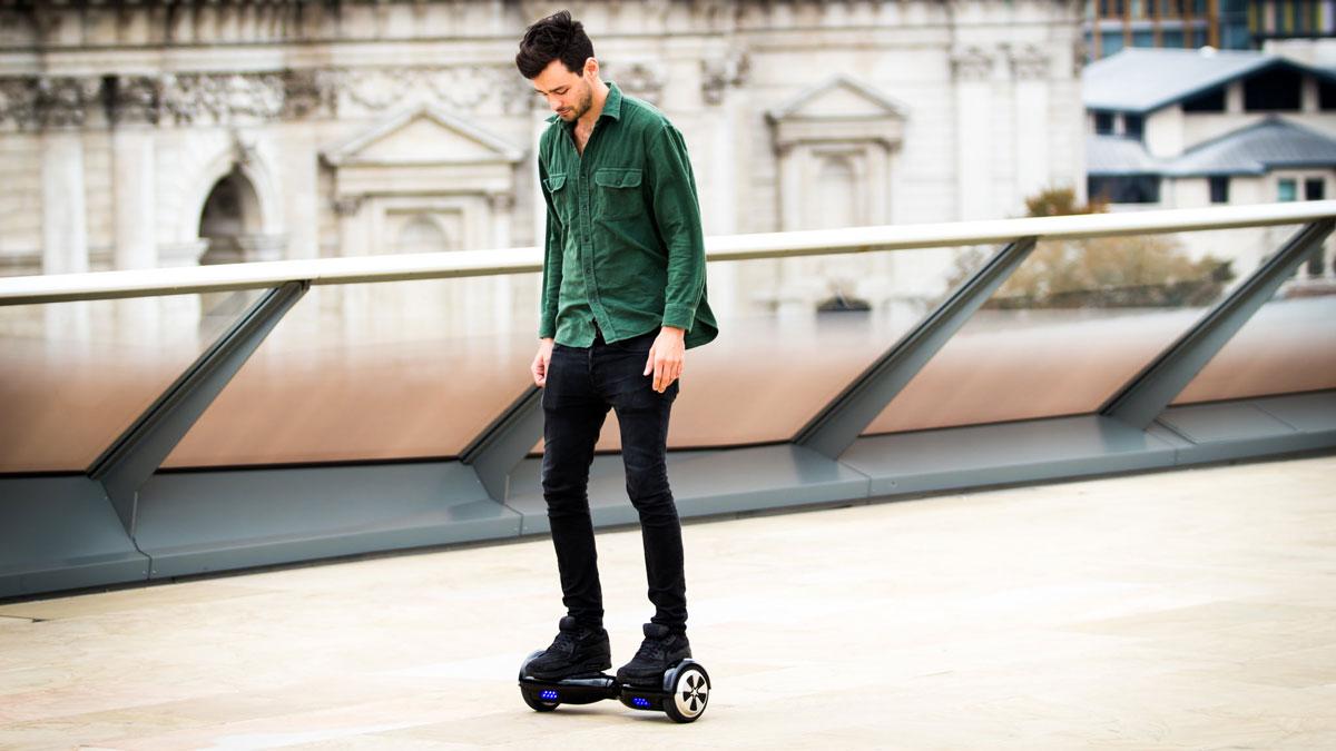 A man rides a hoverboard.