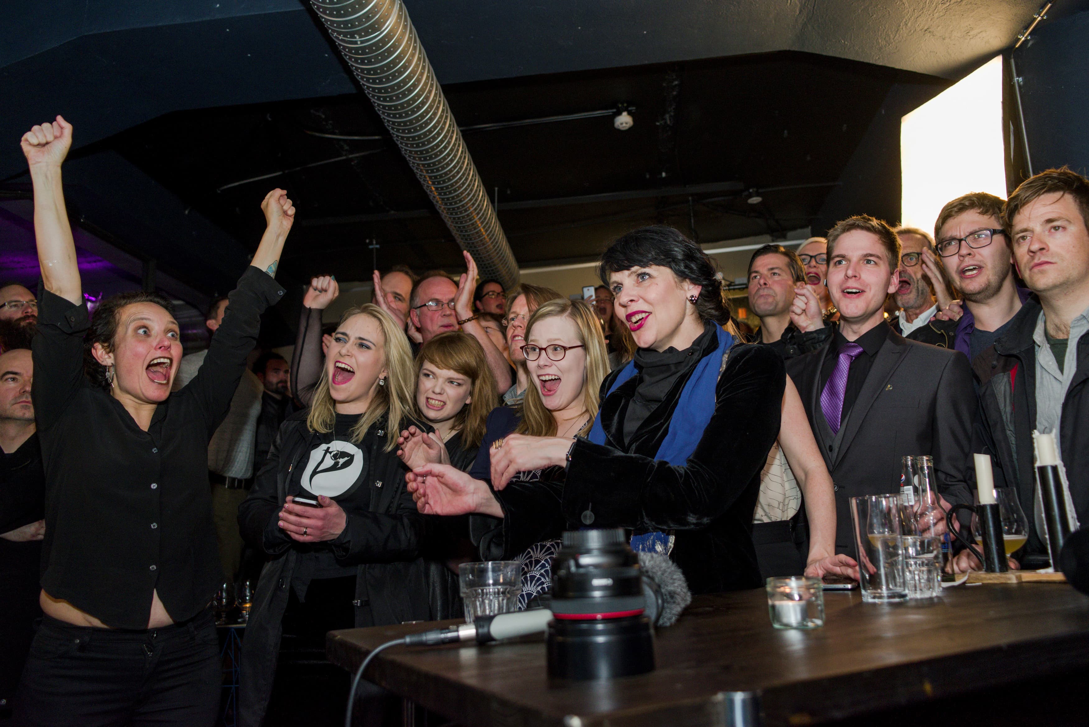 Birgitta Jonsdottir of the Pirate Party reacts alongisde party members