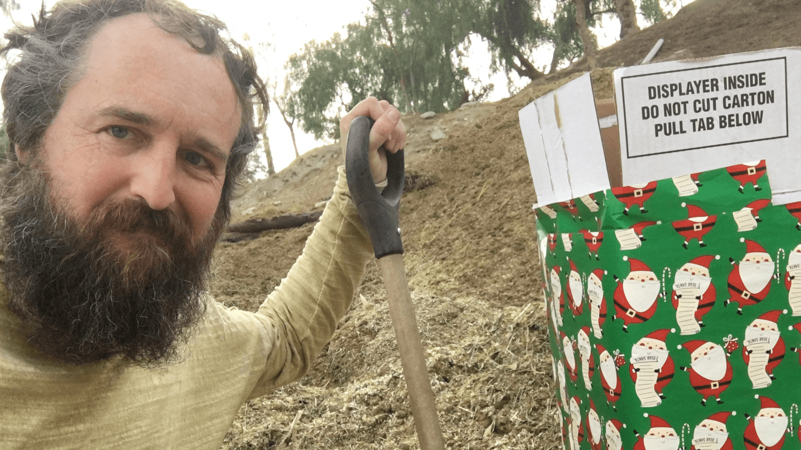 Robert Strong is seen next to a gift-wrapped box in this photo released by Robert Strong of Eagle Rock, California, on Dec. 25, 2017.