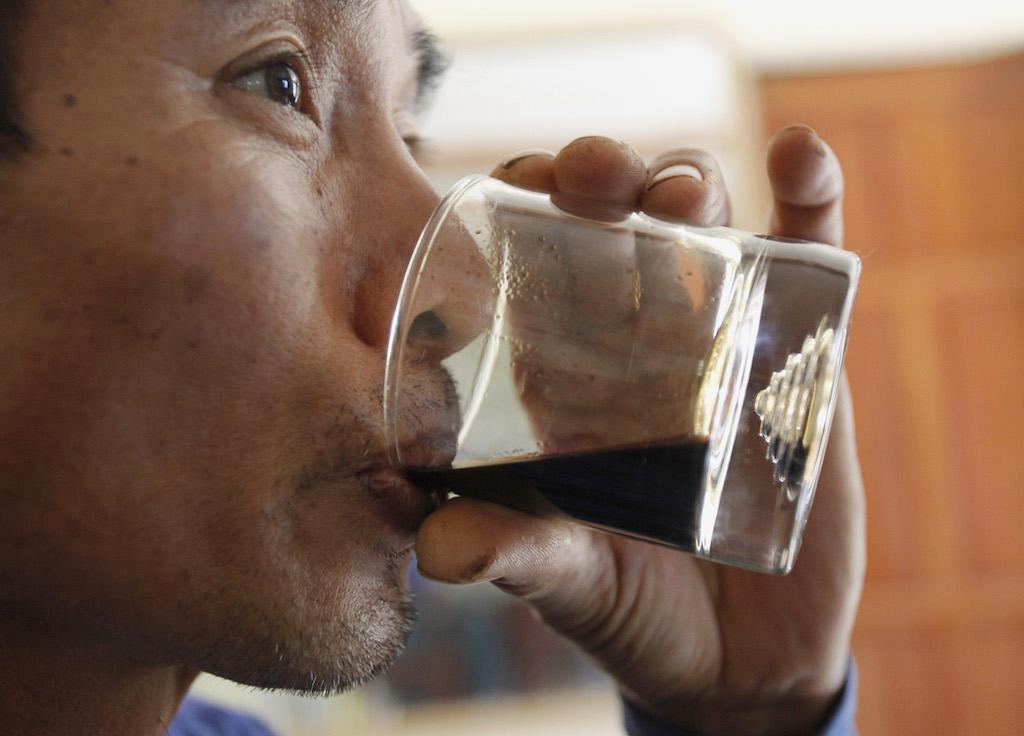 A man drinks coffee at his "weasel coffee" farm in Cang village, northwest Vietnam, Oct. 4, 2011.