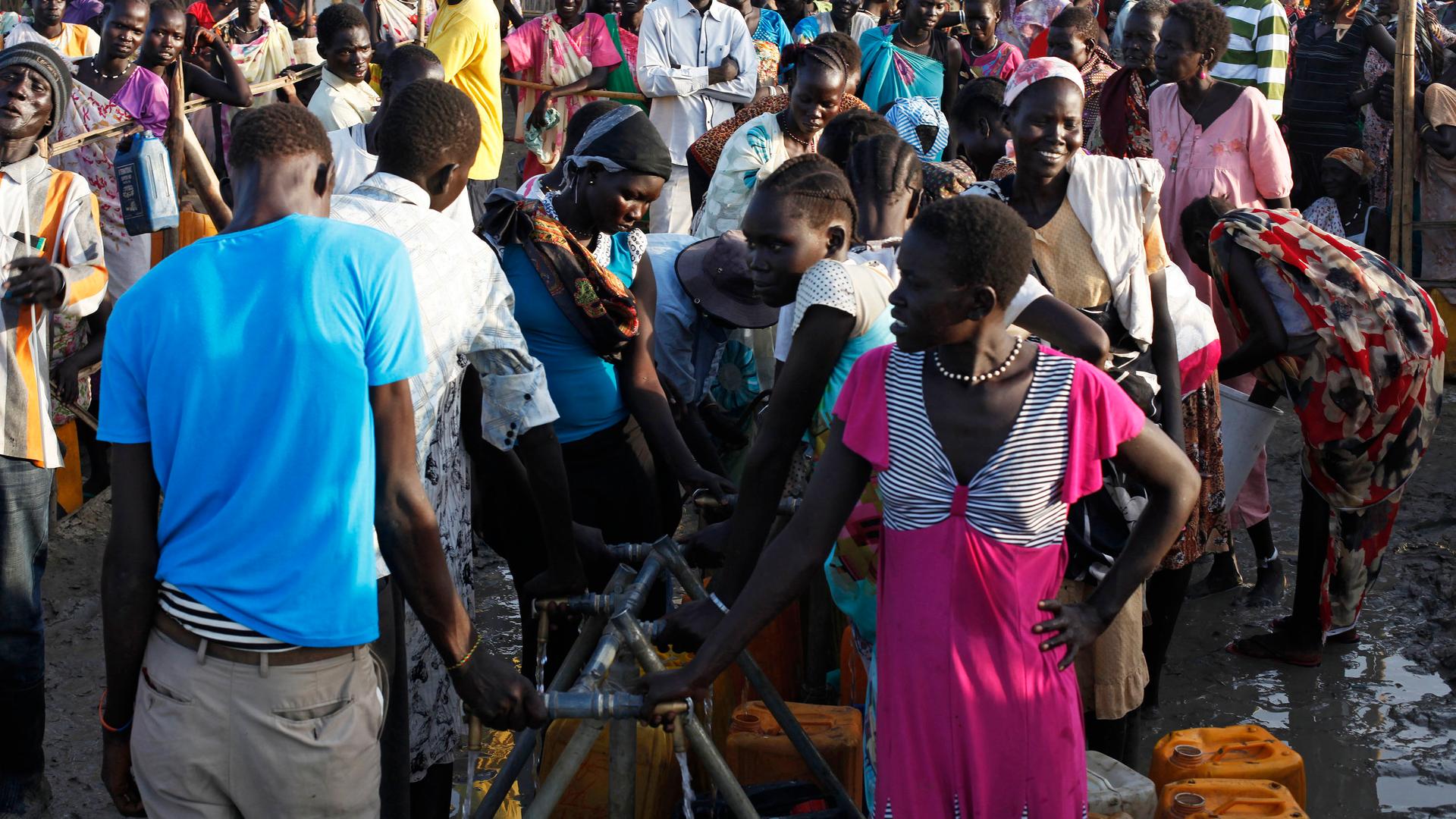People displaced by the fighting wait to get clean water at a water point in a camp for internally displaced persons (IDPs) at the United Nations (UN) base in Bentiu, Unity State.