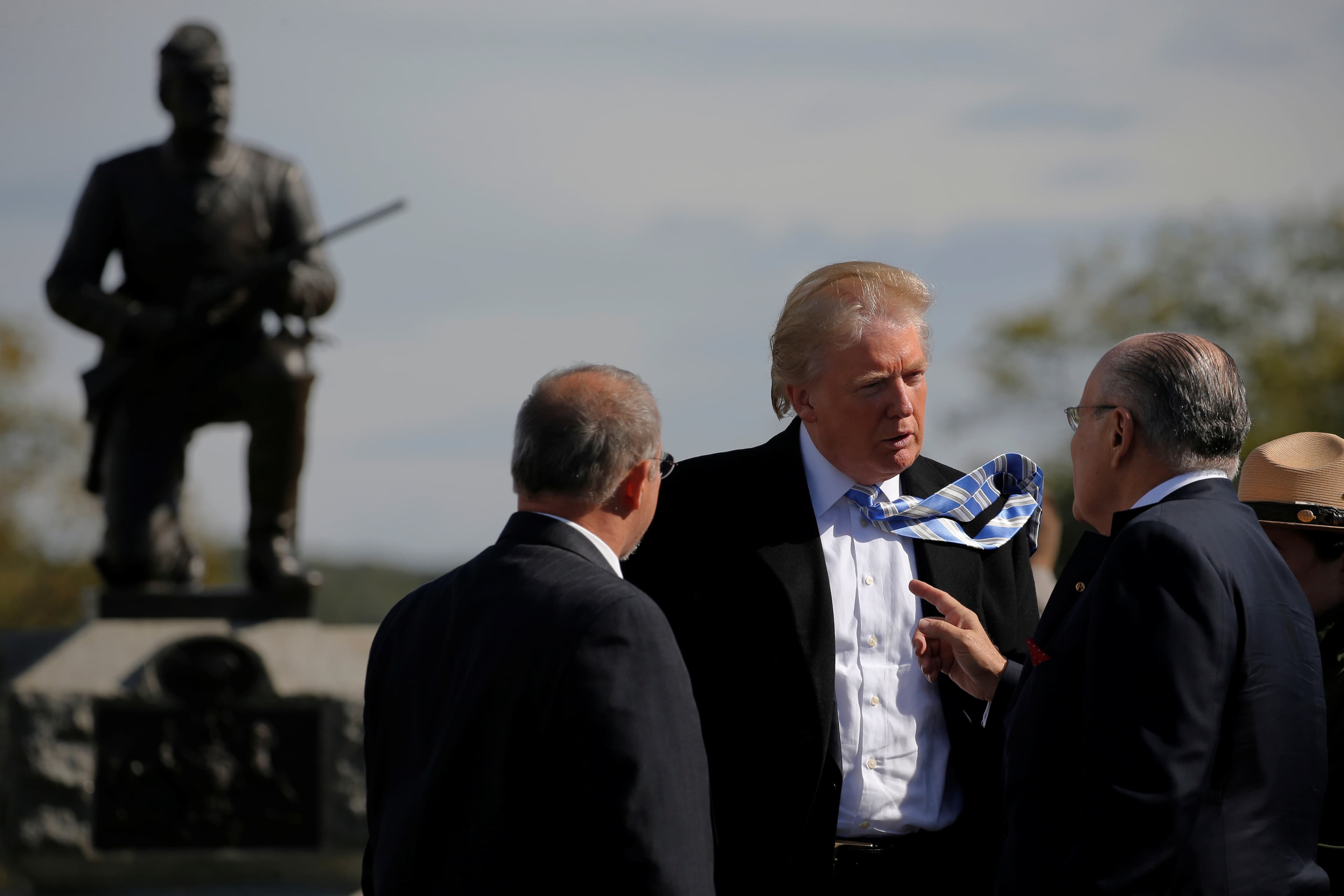 Republican US presidential nominee Donald Trump speaks with former New York mayor Rudy Giuliani