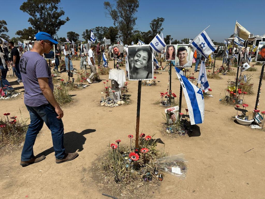 Visitors gather at a memorial on the site of the Nova music festival, where Hamas militants attacked on Oct. 7, 2023.