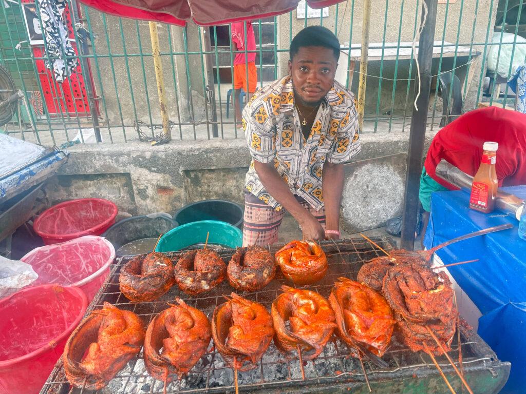 Joseph Sanwah sells grilled catfish in Lagos. He said the fuel scarcity in Nigeria has shot up the price of fresh catfish.