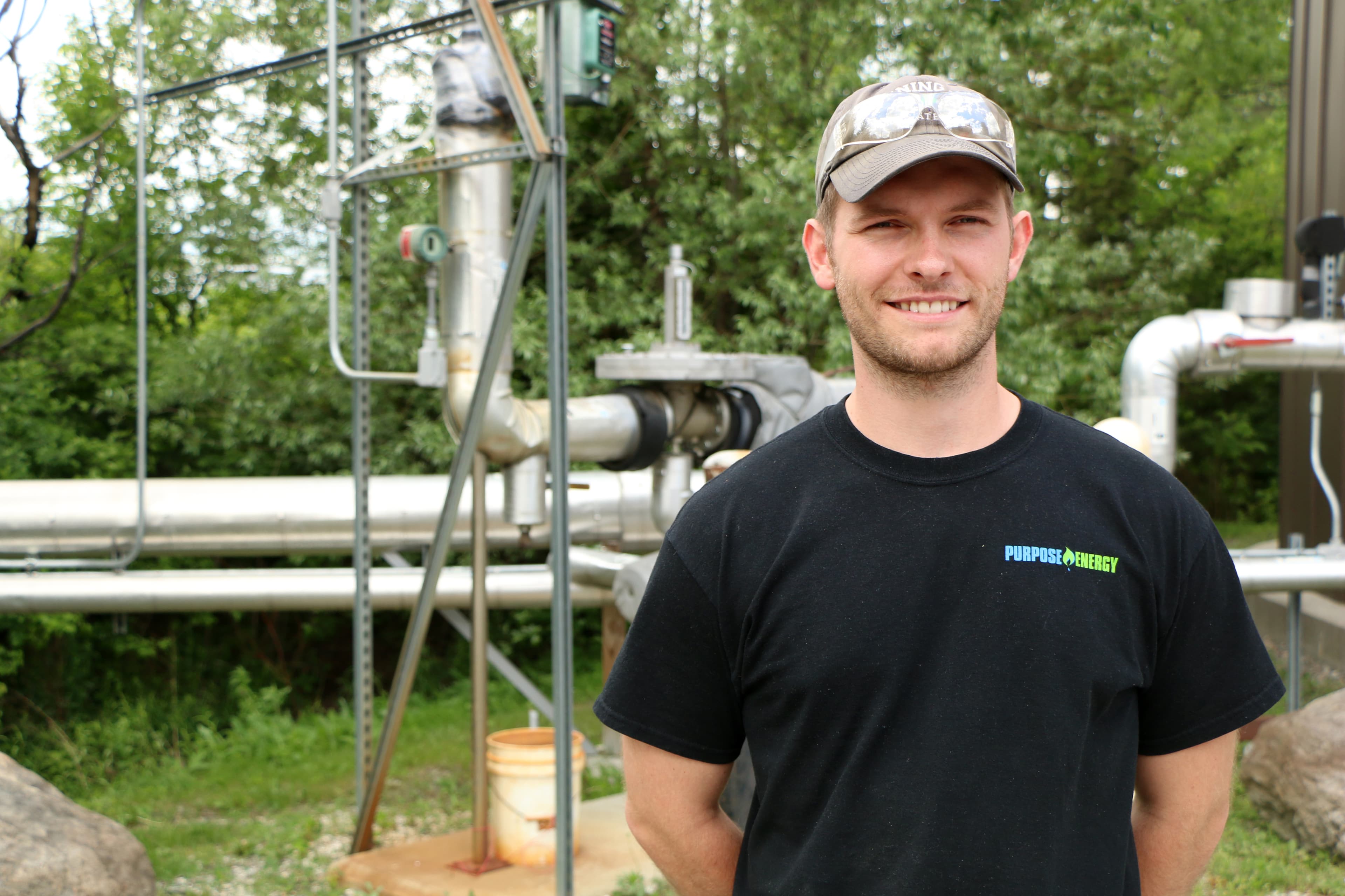 Purpose Energy's Hasper Kuno stands near part of the company's wastewater digester at the Magic Hat Brewery. The system produces methane gas to help power the brewery's operations.