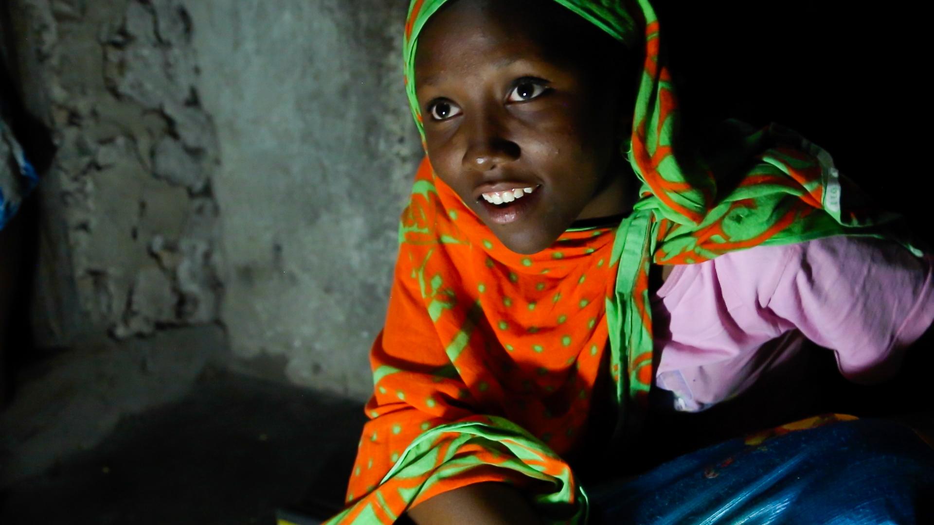 Fourteen year-old Nuru Sheha studies at night in the light of solar-powered LED lights at home in the village of Matemwe, on the Tanzanian island of Zanzibar. He family's first electrical system was installed by one of Zanzibar's 13 "solar mamas," illiter