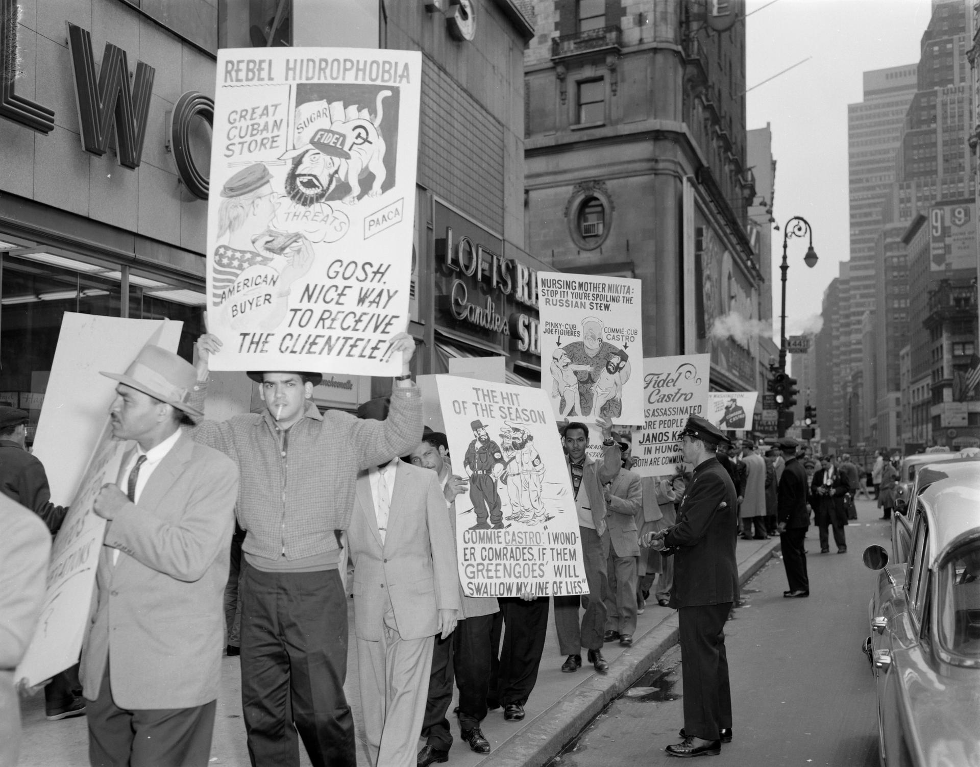 April 1959 - New York City, NY - These pickets were mounted opposite to the Hotel Astor in Times Square, where Cuban leader Fidel Castro was addressing the Overseas Press Club. Numerous police officers and federal agents kept watch over the protesters.