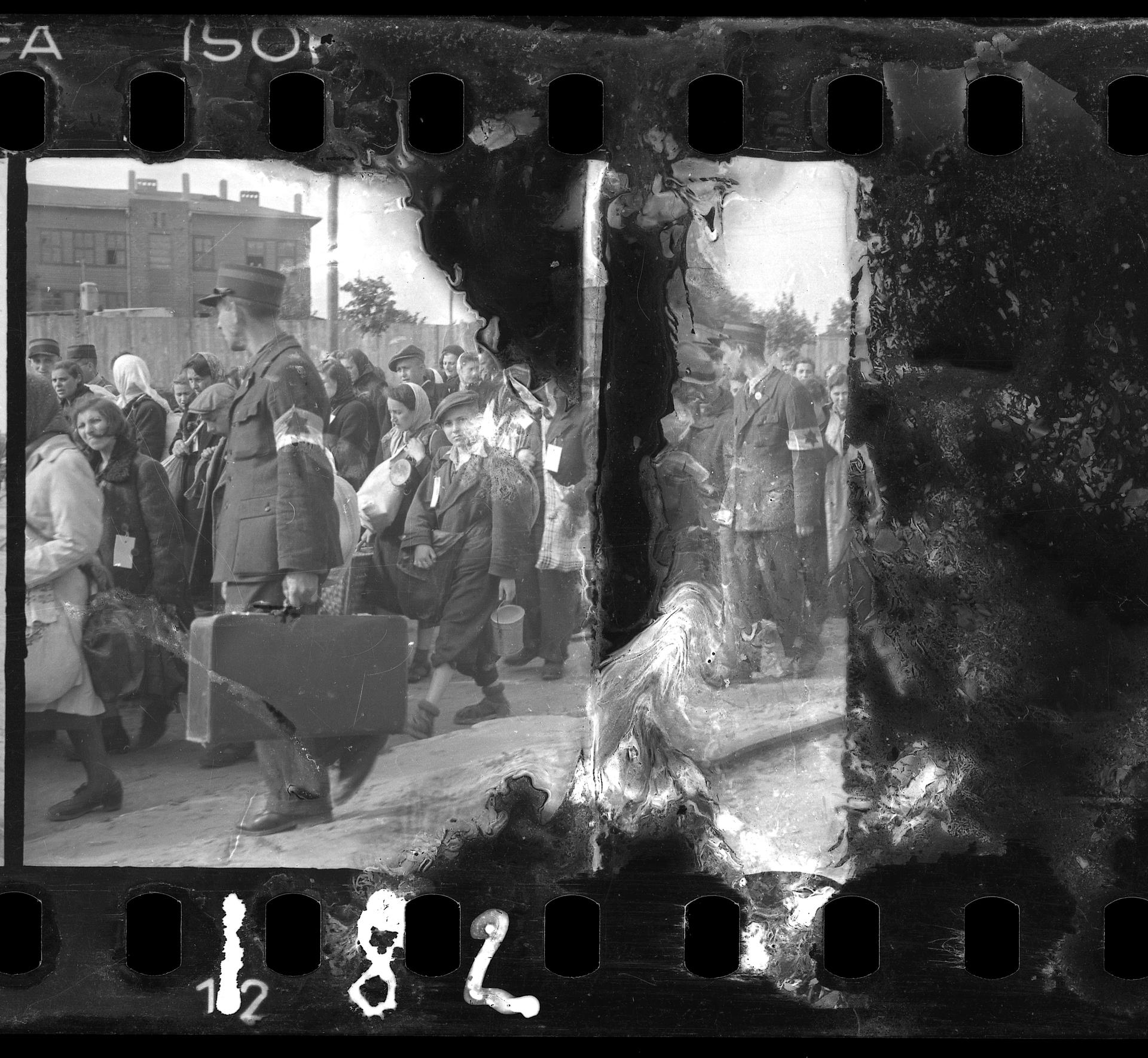 Ghetto police escorting residents for deportation. Henryk Ross (Polish, 1910–1991).