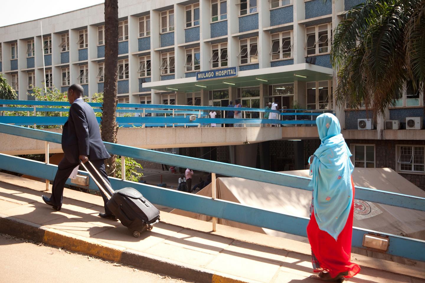 People walk past Mulago Hospital in Kampala, Uganda. At Mulago, patients in a research trial receive CrAg LFA, a screening that can detect the presence of cryptococcal meningitis, enabling the lethal disease to be cured before symptoms arise.