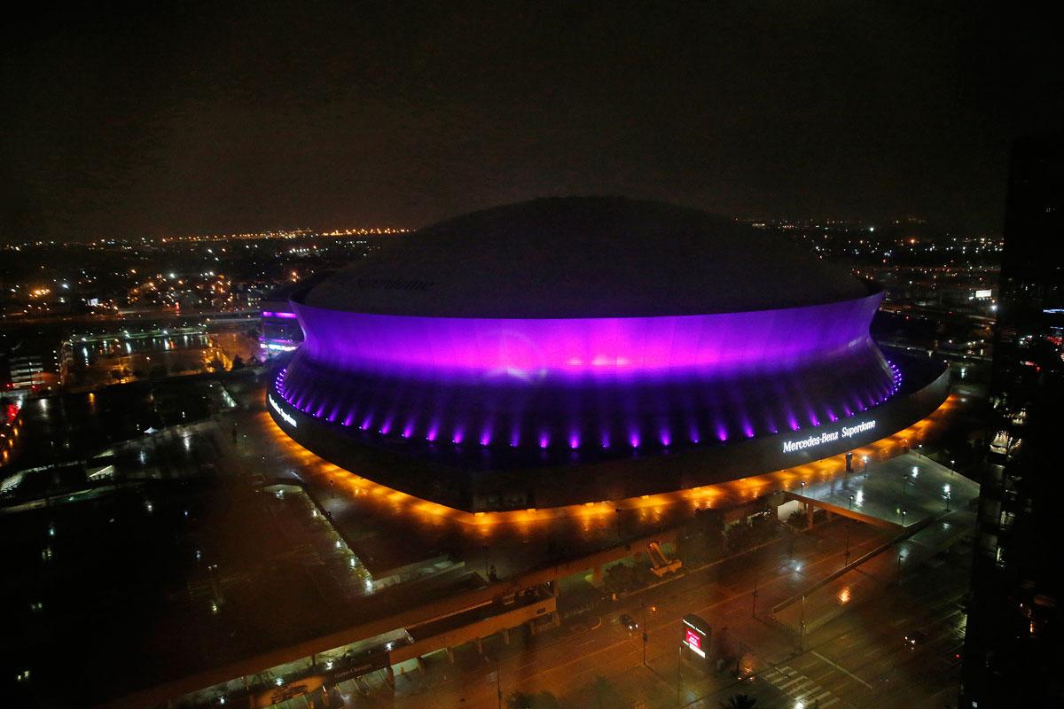 The Mercedes-Benz Superdome is lit up in the color purple in New Orleans.
