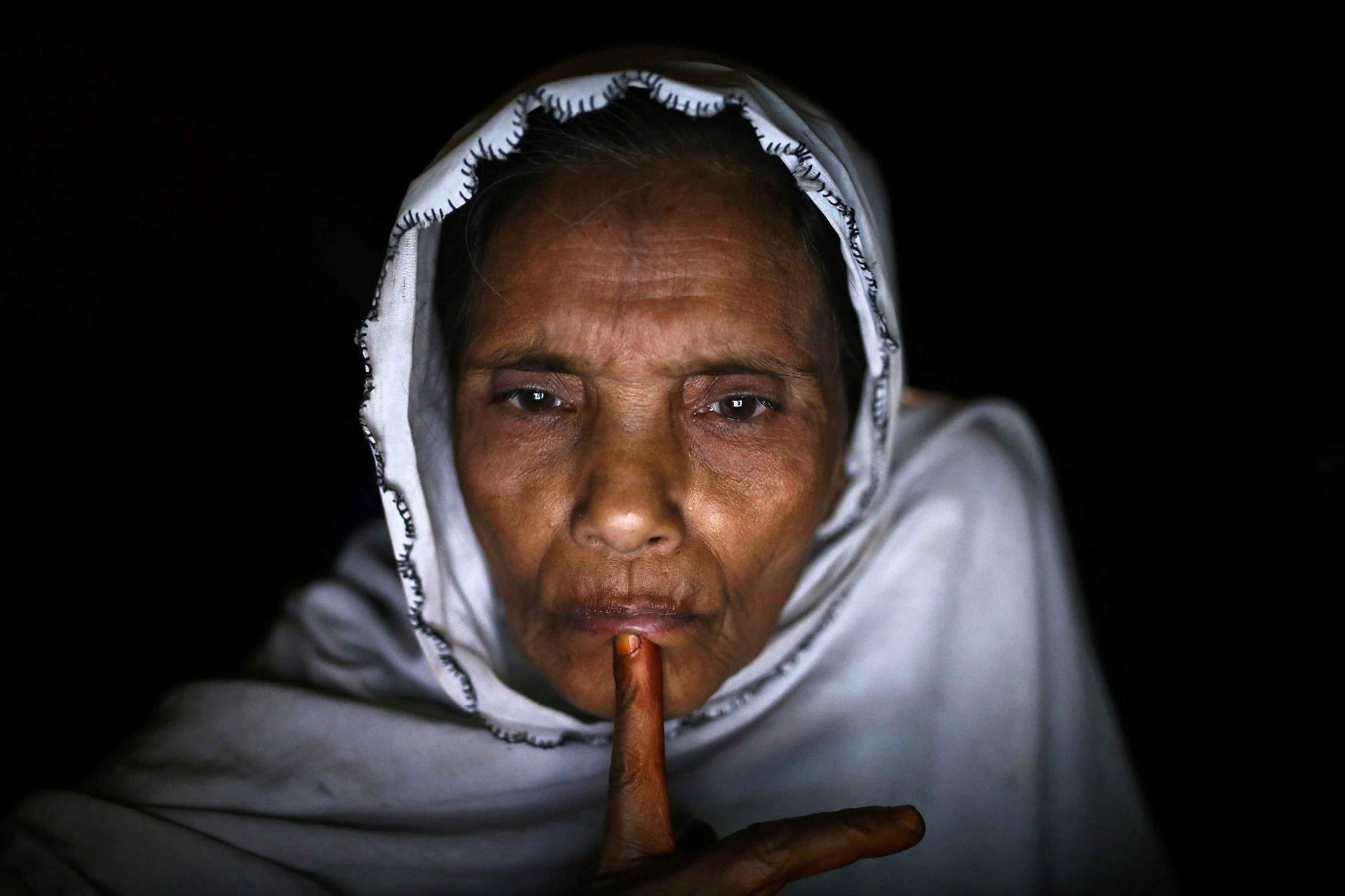Norbanu, a 60-year-old Rohingya, speaks with her daughter's boyfriend, who is now in Indonesia, from an Internet hut in Thae Chaung village. He has broken his promise to send for her, Norbanu tells him, so she will now marry off her daughter to another ma