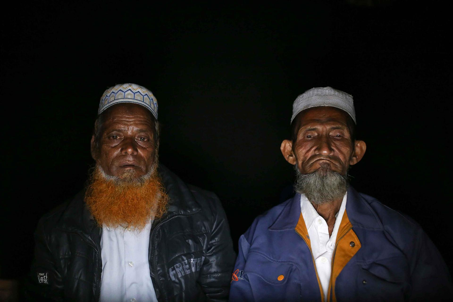 Muhammad Ali (L) and his cousin wait for the call to get through to Muhammad's son in Malaysia. The call never went through. Operators of the huts charge customers 10 cents a minute to talk to relatives who have left Rakhine State by boat to seek work ove