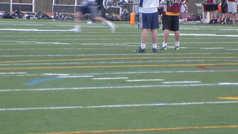 Medway High School's brilliant green artificial turf field uses controversial crumb rubber — chopped up tires, that sometimes contain materials believed to be carcinogenic. April 2015.