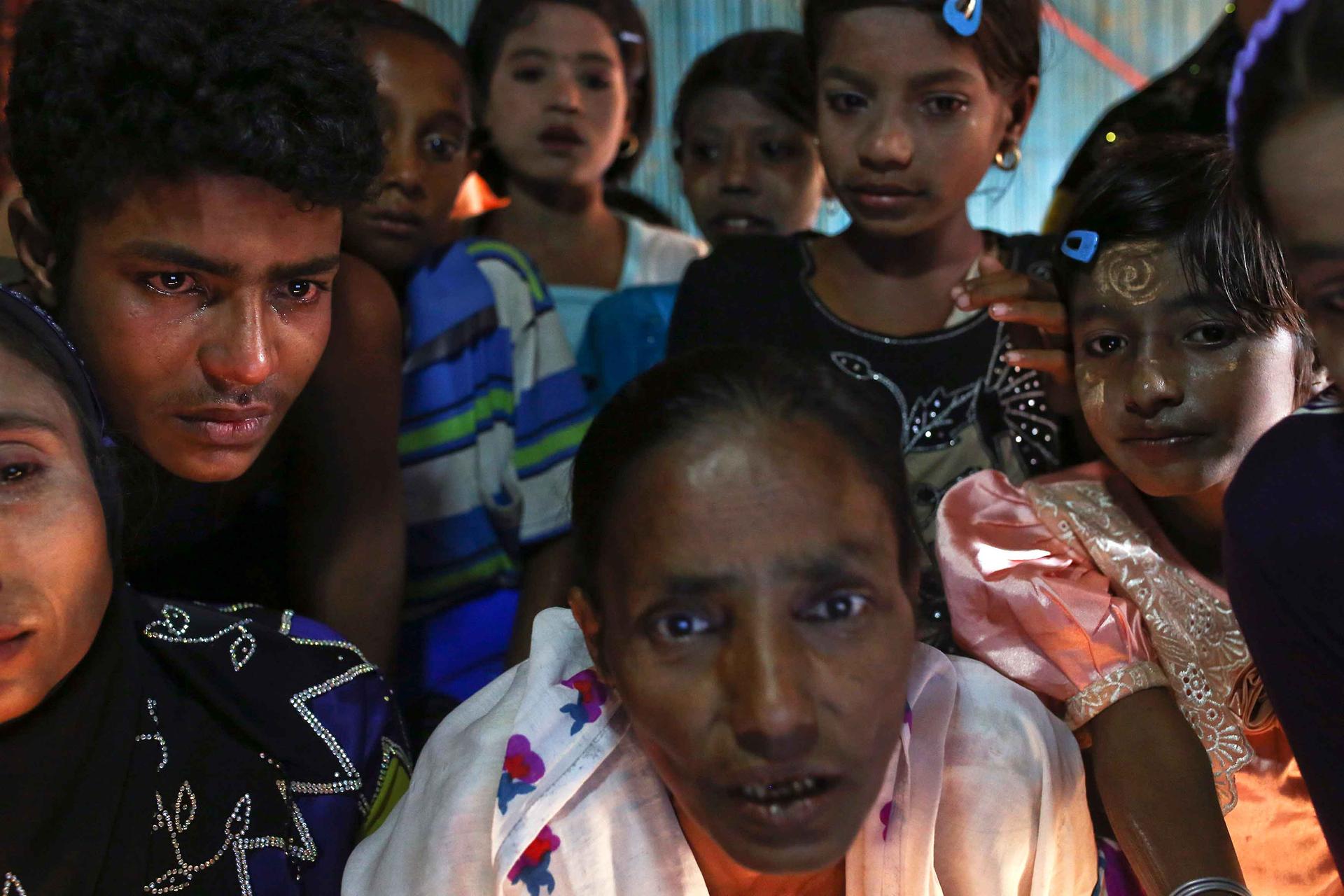 Rohingya people, some crying, video-chat with a big group of their relatives in Bangladesh.