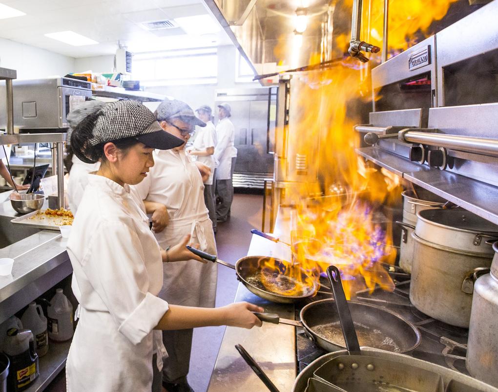 Transformation: Nhu Le cooks in class at Worcester Technical High School’s commercial kitchen. A $90 million facility and a new curriculum have made the school, once among Massachusetts’ worst, a showplace.