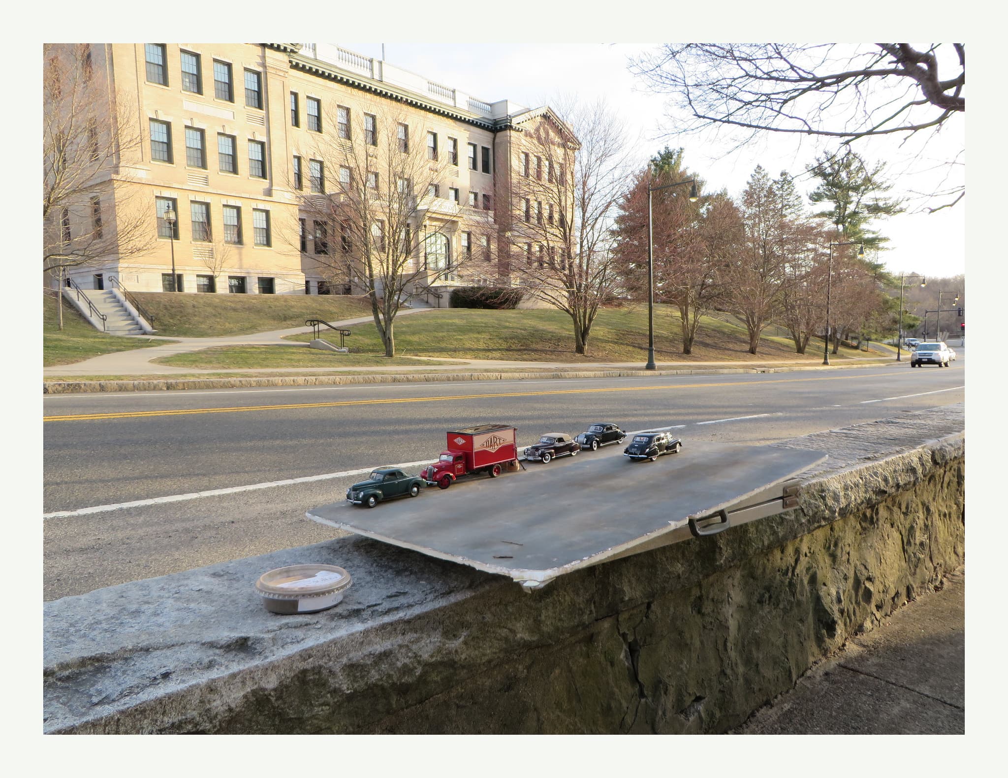 Setting up a shot of a model moving truck alongside a real street.