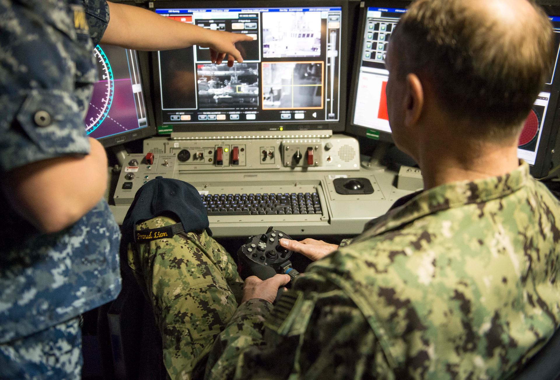 At the controls of the Navy's new laser weapon, aboard the USS Ponce.