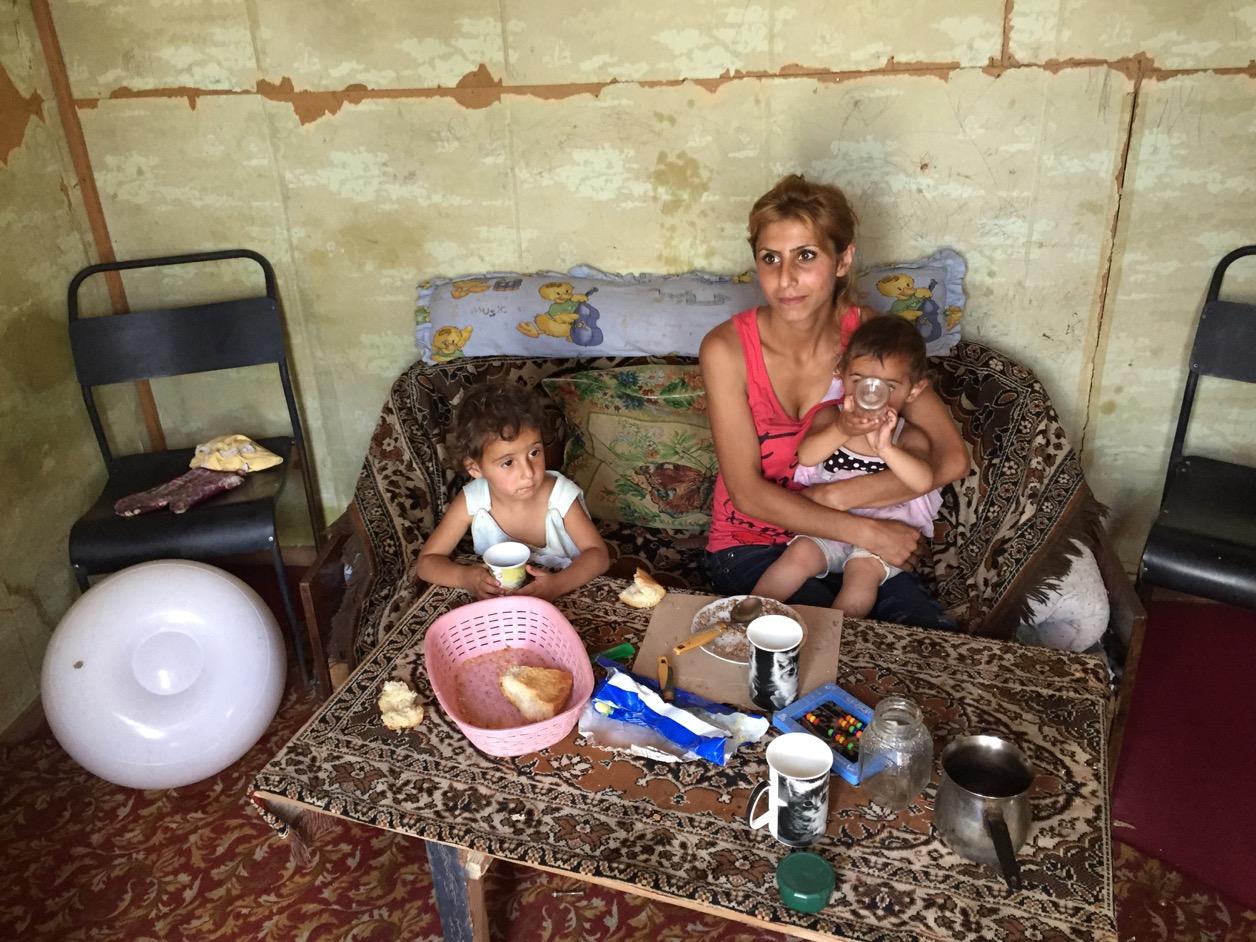 Melina fed her 2- and 3-year-old daughters in her domik in Armenia while her husband Artyom worked in Russia. He has since returned to be with his family but can’t find work.