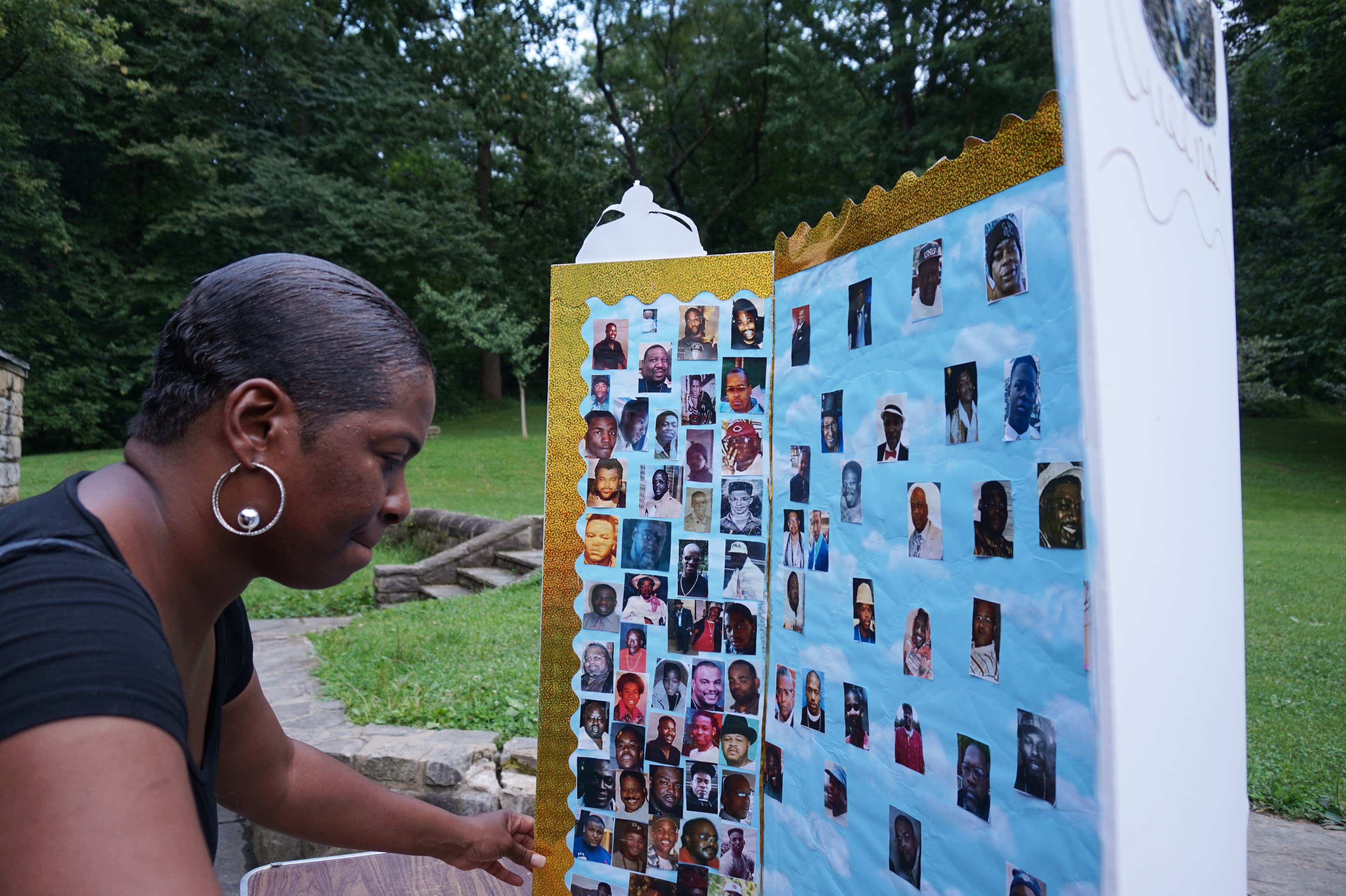 Woman looking at board with small photos of people